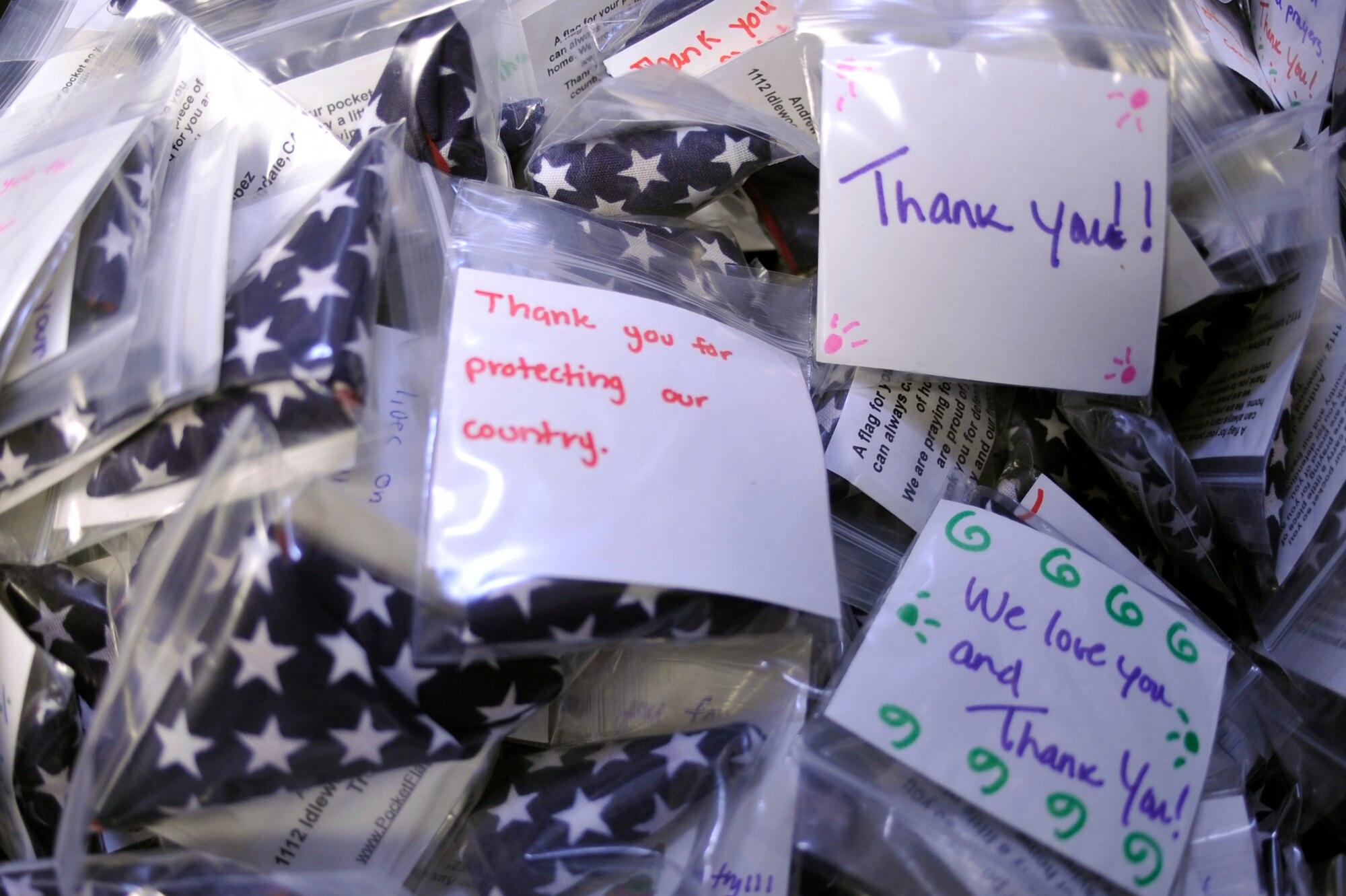 VANDENBERG AIR FORCE BASE, Calif. -- U.S. flags are packaged with messages from family members on base to support the Global Hearts deployed members at the Airman and Family Readiness Center here Wednesday, Sept. 7, 2011. The Global Hearts Group supports deployed military members and their dependents with donated and purchased items supplied at the Airman and Family Readiness Center. (U.S. Air Force photo/Staff Sgt. Andrew Satran) 

  
 
  

   