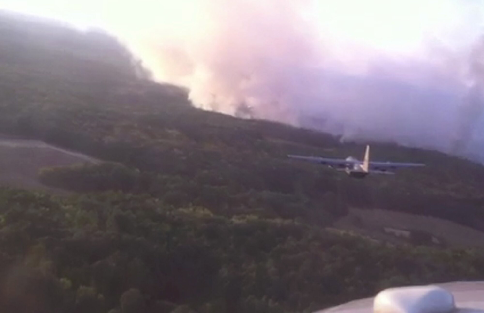 A Modular Airborne Firefighting System-equipped C-130 Hercules prepares for a fire retardant run over a wildfire Sept. 12 in Harrison County, Texas. Four MAFFS C-130 aircraft, assigned to the 302nd Air Expeditionary Group based at Austin-Bergstrom International Airport in Austin, Texas, provided approximately 12,000 gallons of retardant to two fires in the northeast Texas county. (Courtesy photo)