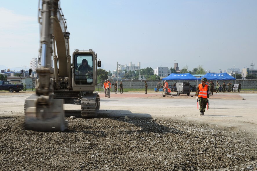 TAEGU AIR BASE, Republic of Korea -- Republic of Korea Air Force 11th Civil Engineer Squadron members participate in the 2011 Combined Airfield Damage Repair Exercise with Airmen from the 8th Civil Engineer Squadron here Sept. 8. The purpose of the exercise was to enhance interoperability, evaluate capabilities and strengthen combined relationships with Republic of Korea Air Force members. (U.S. Air Force photo/Senior Airman Brittany Y. Bateman)