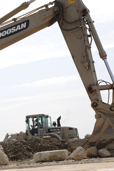 TAEGU AIR BASE, Republic of Korea -- An Airman from the Republic of Korea Air Force 11th Civil Engineer Squadron, uses a loader to repair a large crater here Sept. 8. The purpose of the exercise was to enhance interoperability, evaluate capabilities and strengthen combined relationships between U.S. and ROKAF members. (U.S. Air Force photo/Senior Airman Brittany Y. Bateman)