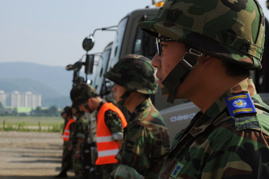 TAEGU AIR BASE, Republic of Korea -- Republic of Korea Airmen from the 11th Civil Engineer Squadron stationed here, prepare to participate in the 2011 Combined Airfield Damage Repair Exercise with Airmen from the 8th Civil Engineer Squadron here Sept. 8. The purpose of the exercise was to enhance interoperability, evaluate capabilities and strengthen combined relationships  between U.S. and Republic of Korea Air Force members. (U.S. Air Force photo/Senior Airman Brittany Y. Bateman)