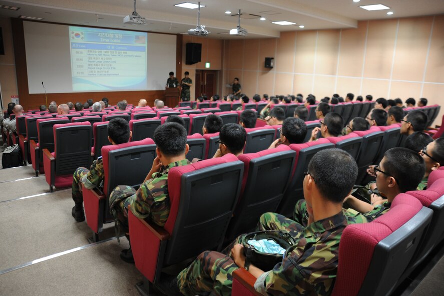 TAEGU AIR BASE, Republic of Korea -- Airmen from the 8th Civil Engineer Squadron and Republic of Korea Airmen from the 11th Civil Engineer Squadron stationed here, receive a briefing during the 2011 Combined Airfield Damage Repair Exercise here Sept. 8. The purpose of the exercise was to enhance interoperability, evaluate capabilities and strengthen combined relationships between U.S. and Republic of Korea Air Force members. (U.S. Air Force photo/Senior Airman Brittany Y. Bateman)