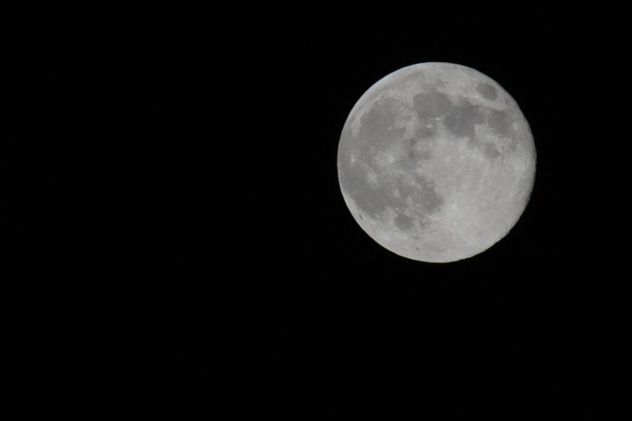 A full moon drifts across the night sky over Barksdale Air Force Base, La., Sept. 12. Airmen work throughout the night to ensure B-52H Stratofortresses and other aircraft on base are able to accomplish the mission any time, anywhere. (U.S. Air Force photo/Airman 1st Class Micaiah Anthony)(RELEASED)