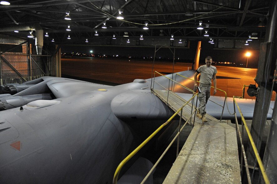 Senior Airman Derrick Cross, 2nd Maintenance Squadron Fabrication Flight, walks across a platform connected to a B-52H Stratofortress on Barksdale Air Force Base, La., Sept. 12. Airmen from the fabrication flight respond to calls from other maintenance Airmen throughout the night to fabricate parts for B-52Hs. (U.S. Air Force photo/Airman 1st Class Micaiah Anthony)(RELEASED)