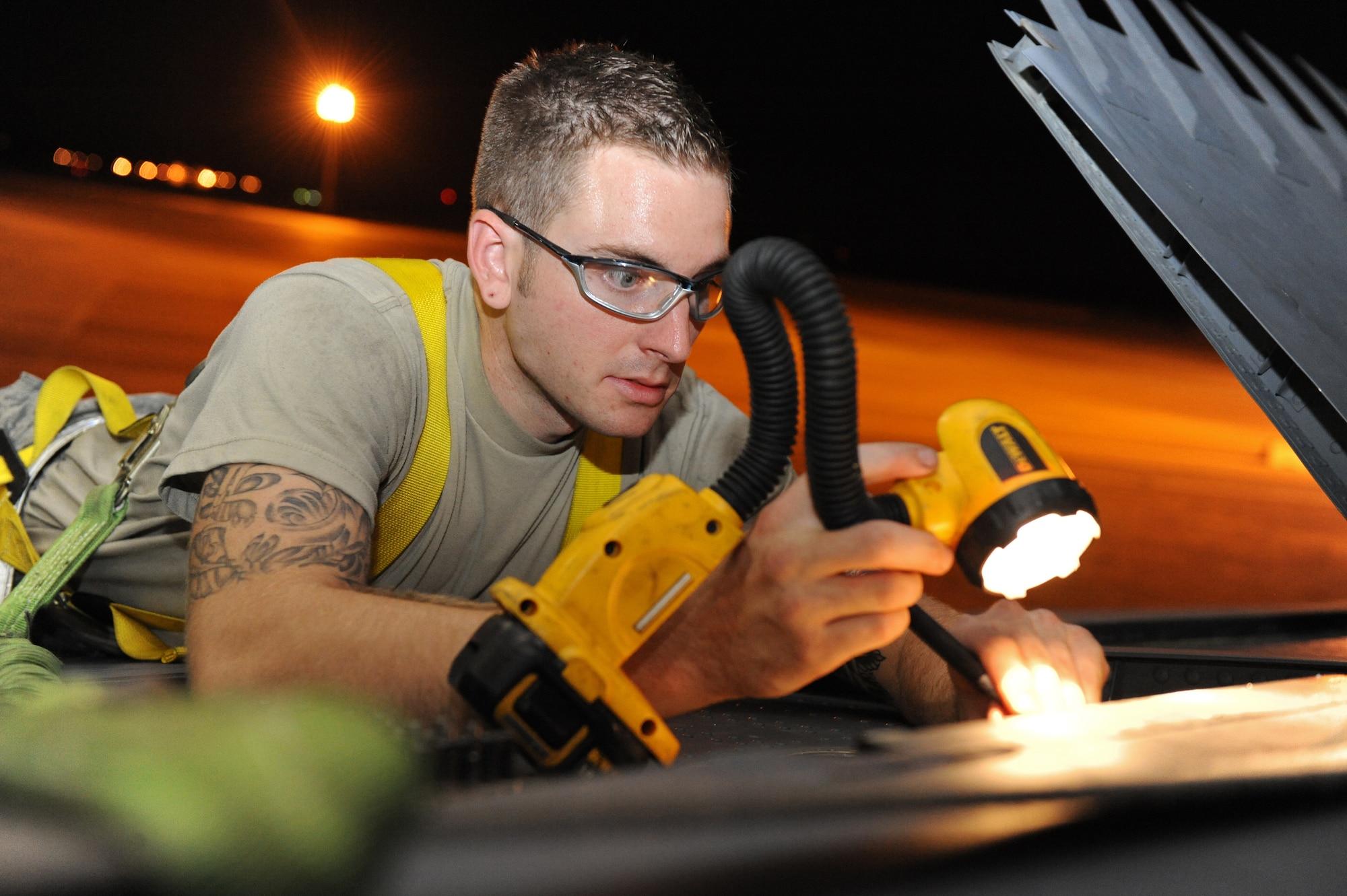 Senior Airman Devin Staats-Walker, 2nd Maintenance Squadron Fabrication Flight, shines a light onto the wing of a B-52H Stratofortress on Barksdale Air Force Base, La., Sept. 12. Airmen from the fabrication flight were sent to repair a broken spoiler on the wing of a B-52H. (U.S. Air Force photo/Airman 1st Class Micaiah Anthony)(RELEASED)