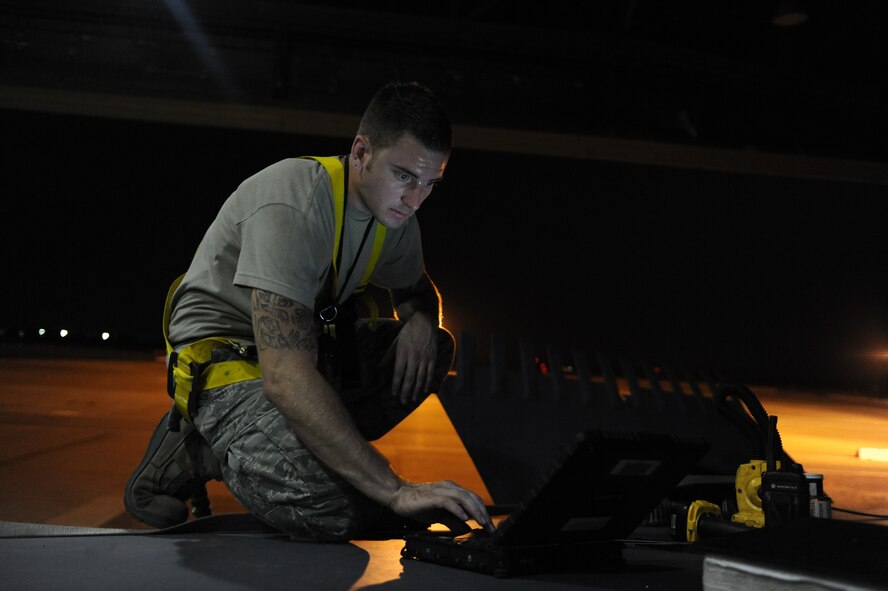 Senior Airman Devin Staats-Walker, 2nd Maintenance Squadron Fabrication Flight, uses an E-tool while on top of a B-52H Stratofortress on Barksdale Air Force Base, La., Sept. 12. The E-tool displays step-by-step instructions, also known as technical orders, to assist Airmen in completing their maintenance tasks. (U.S. Air Force photo/Airman 1st Class Micaiah Anthony)(RELEASED)