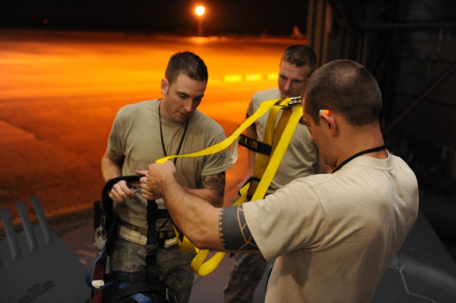 Airmen from the 2nd Maintenance Squadron Fabrication Flight inspect a harness while on top of a B-52H Stratofortress in a hangar on Barksdale Air Force Base, La., Sept. 12. As a safety measure, Airmen are required to wear harnesses when working 10 feet or higher off the ground. (U.S. Air Force photo/Airman 1st Class Micaiah Anthony)(RELEASED)