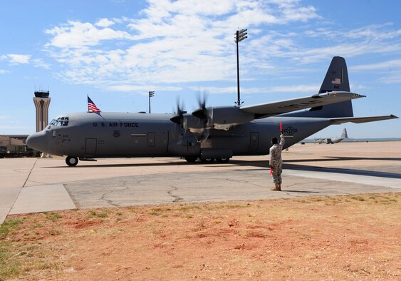 DYESS AIR FORCE BASE, Texas - A marshaller brings in the 317th Airlift Group's newest C-130J here Sept. 8. The delivery, by Lt. Gen. Robert R. Allardice, Commander, 18th Air Force, was the sixth in the 317th's continuing transition to the new aircraft. Dyess is slated to become home to the Air Force's largest C-130J fleet when it receives its 28th and final C-130J in 2013.