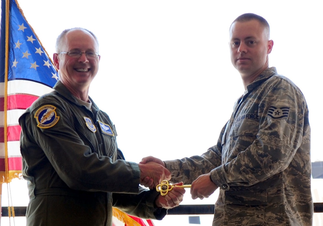 DYESS AIR FORCE BASE, Texas - Lt. Gen. Robert R. Allardice, Commander, 18th Air Force, presents a ceremonial key for the 317th Airlift Group's newest C-130J to dedicated crew chief Staff Sgt. Michael Smith here Sept. 8. The delivery was the sixth in the 317th's continuing transition to the new aircraft. Dyess is slated to become home to the Air Force's largest C-130J fleet when it receives its 28th and final C-130J in 2013. 