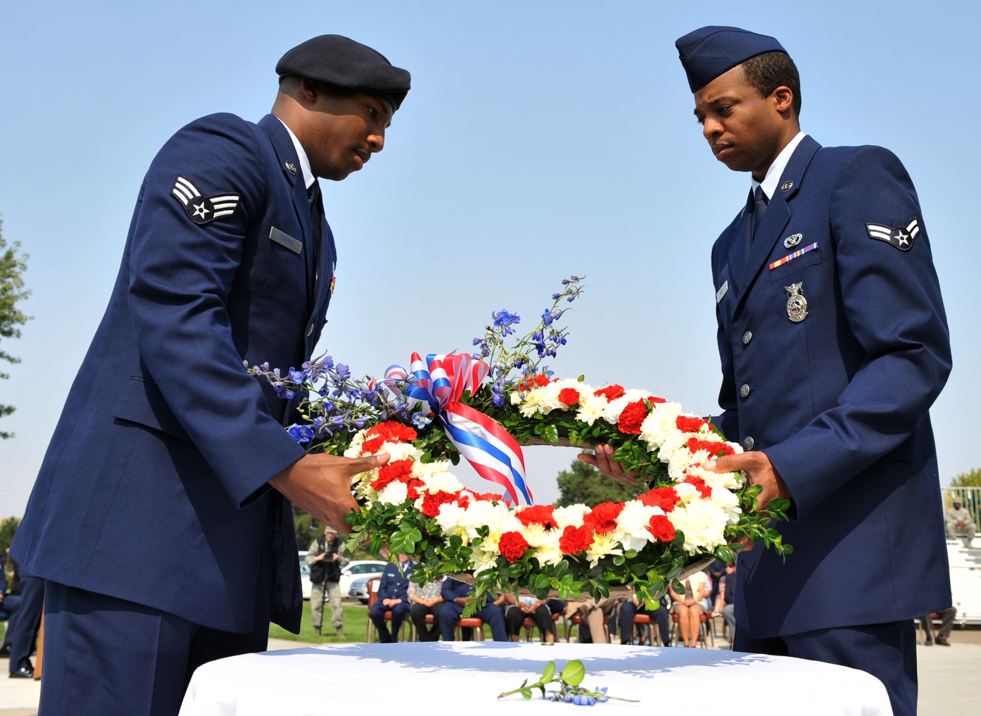 MOUNTAIN HOME AIR FORCE BASE, Idaho – Airman 1st Class Christian Burt and Senior Airman Norvell Cooper hold a wreath to be placed at the base of the flagpole during a retreat ceremony here Sept. 9.The ceremony was the first event of Air Force Appreciation Day, an annual event sponsored by the city of Mountain Home. (U.S. Air Force photo by Airman 1st Class Heather Hayward)