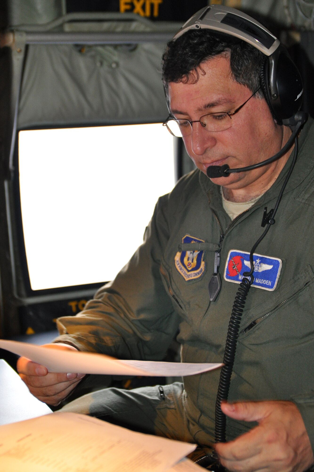Lt. Col. Warren Madden, 53rd Weather Reconnaissance Squadron aerial reconnaissance weather officer, looks over some paperwork to help monitor the weather as the aircrew prepares to fly into Tropical Storm Maria Sept. 9. The Hurricane Hunters were completing the mission from operations held in St. Croix. (U.S. Air Force photo by Staff Sgt. Valerie Smock)