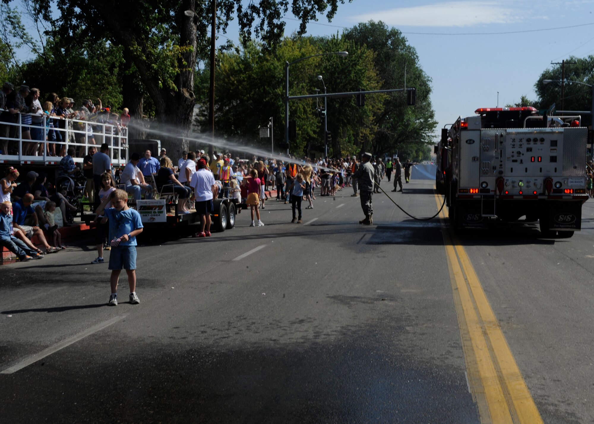 MOUNTAIN HOME, Idaho – Lt. Col. Michal Holliday, 366th Civil Engineer Squadron commander, hoses down senior leaders and parade judges during the Air Force Appreciation Day Parade here, Sept. 10. (U.S. Air Force photo by Senior Airman Angelina Drake) 