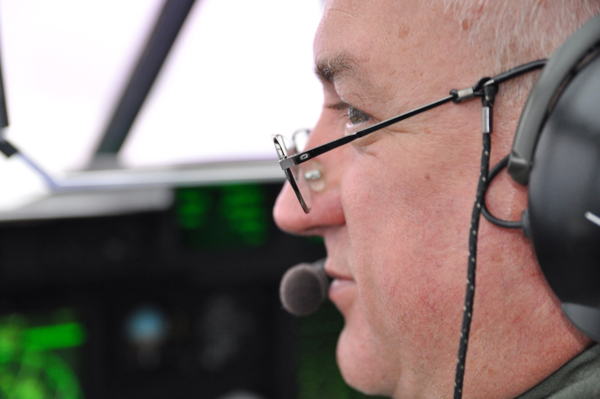 Lt. Col. Bucky Lane, a pilot with the 53rd Weather Reconnaissance Squadron, looks out the window to view the weather conditions from Tropical Storm Maria Sept. 9. The Hurricane Hunters flew through the system before evacuating to Homestead, Florida. (U.S. Air Force photo by Staff Sgt. Valerie Smock)