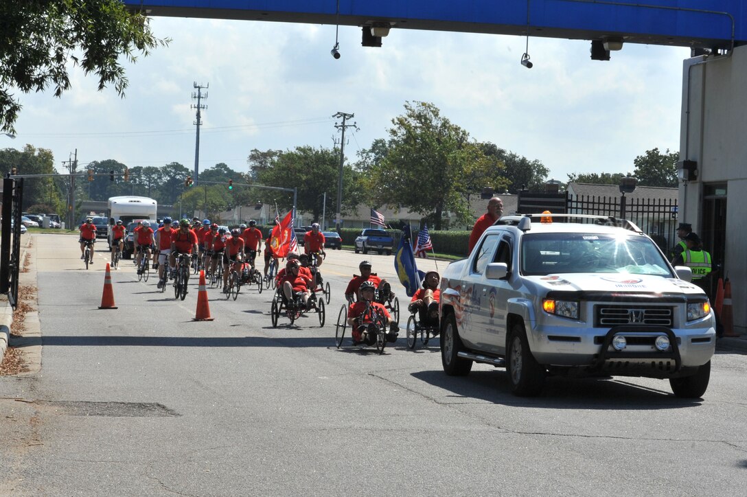 U.S. veterans and active duty members arrive at Naval Station Norfolk during the Warrior Ride 9/11 Tribute Chesapeake Community Challenge Sept. 9, 2011. The riders began at Norfolk Botanical Gardens, rode to Joint Expeditionary Base Little Creek- Fort Story, and ended at Naval Station Norfolk. (U.S. Air Force photo by Airman 1st Camilla Griffin/Released)