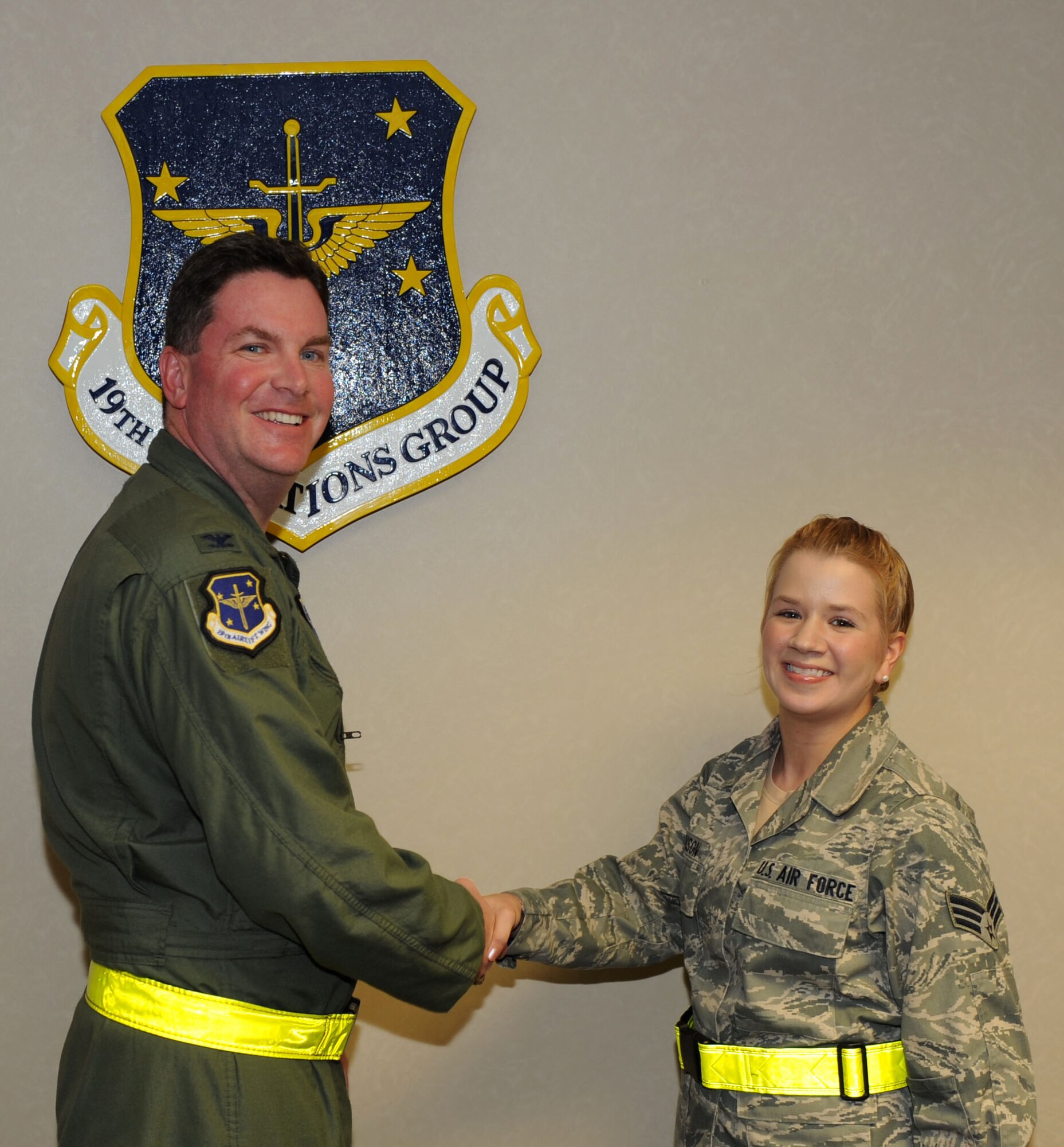 Col. Thomas Crimmins, 19th Airlift Wing vice commander, presents a commander’s coin to Senior Airman Kaelah Swenson, a 19th Operations Group knowledge operations management information assurance officer, Sept. 12, 2011, at Little Rock Air Force Base, Ark. Swenson enforced wing standards by training and in-processing 20 personnel and conducting five records management staff assistance visits. (U.S. Air Force photo by Senior Airman Caleb Pierce)