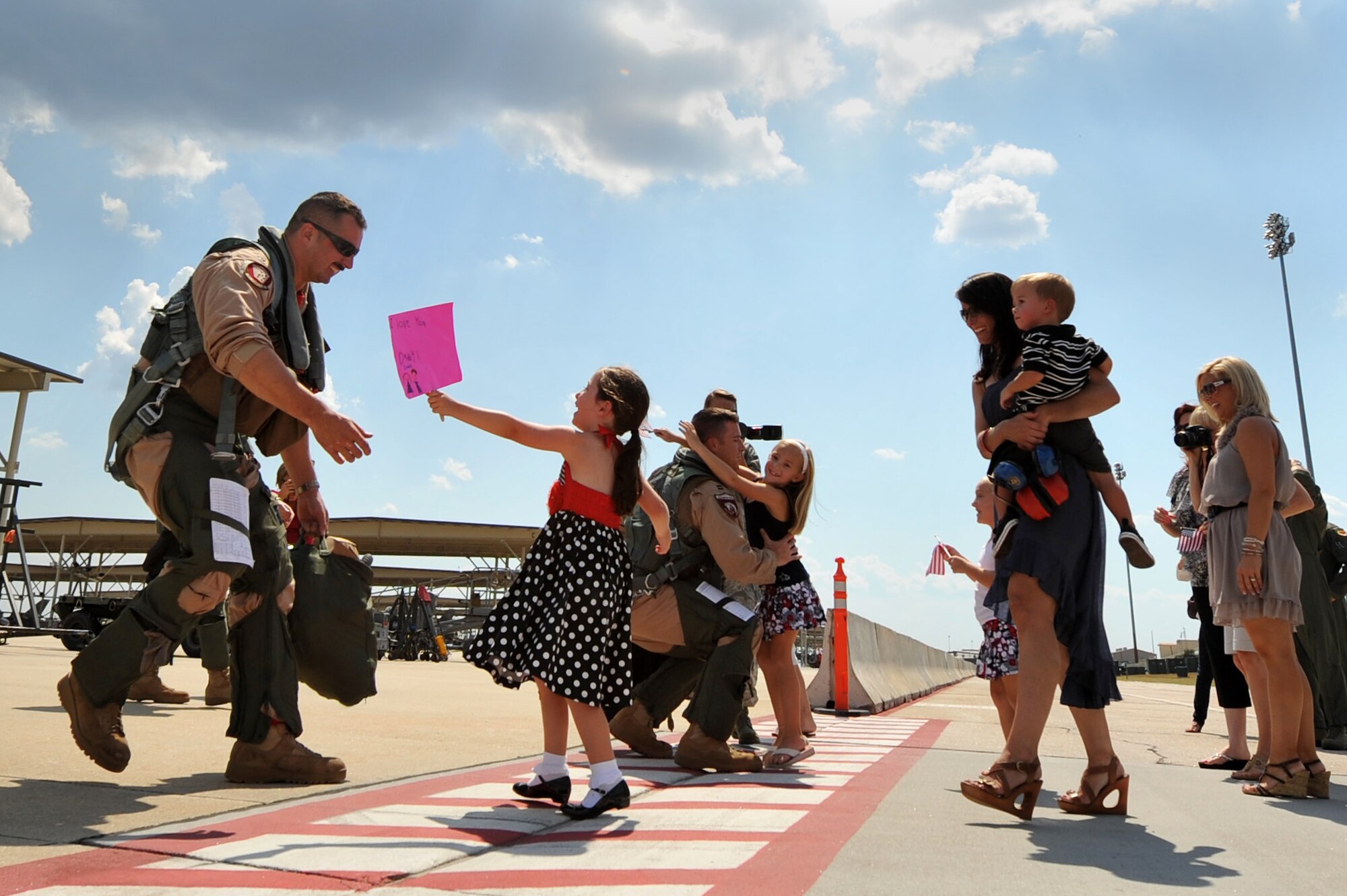 U.S. Air Force F-16 Fighting Falcon pilots assigned to the 77th Fighter Squadron are greeted by their families upon returning from a five month deployment in support of Operation Unified Protector, Sept. 12, 2011, Shaw Air Force Base, S.C. The mission of the 77th FS pilots was to provide air suppression and destruction of enemy defenses. (U.S. Air Force photo by Senior Airman Kenny Holston/Released)


