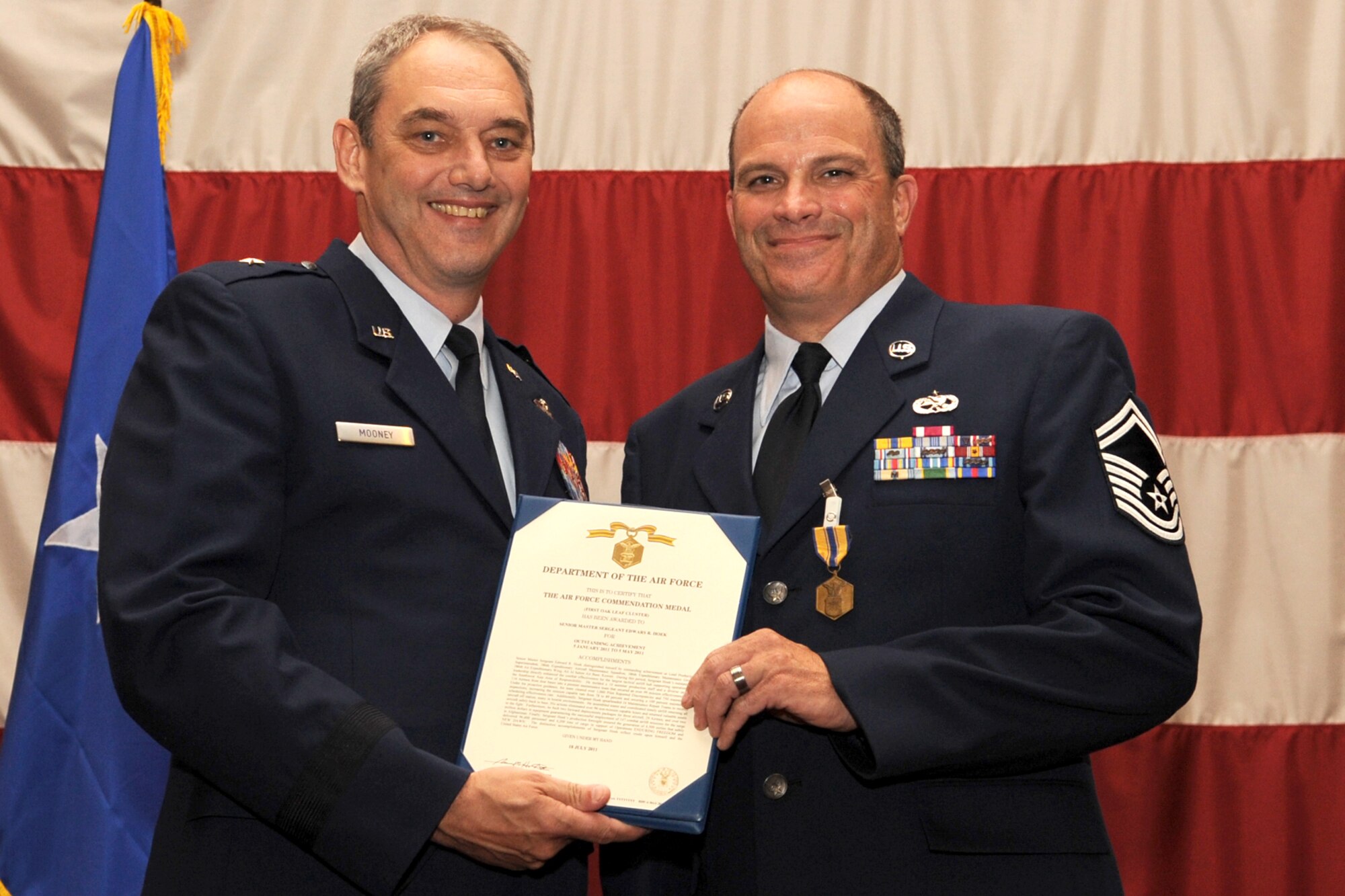 U.S. Air Force Brig. Gen. John J. Mooney III, 307th Bomb Wing commander, presents the Air Force Commendation Medal to Senior Master Sgt. Edmund Hoek at Barksdale Air Force Base, La., Sept. 11, 2011. Hoek received the citation for outstanding achievement as Lead Production Superintendent, 386th Air Expeditionary Wing, Ali Al Salem Air Base, Kuwait, during the period of Jan. 5, 2011 to May 5, 2011. (U.S. Air Force photo by Master Sgt. Greg Steele/Released)