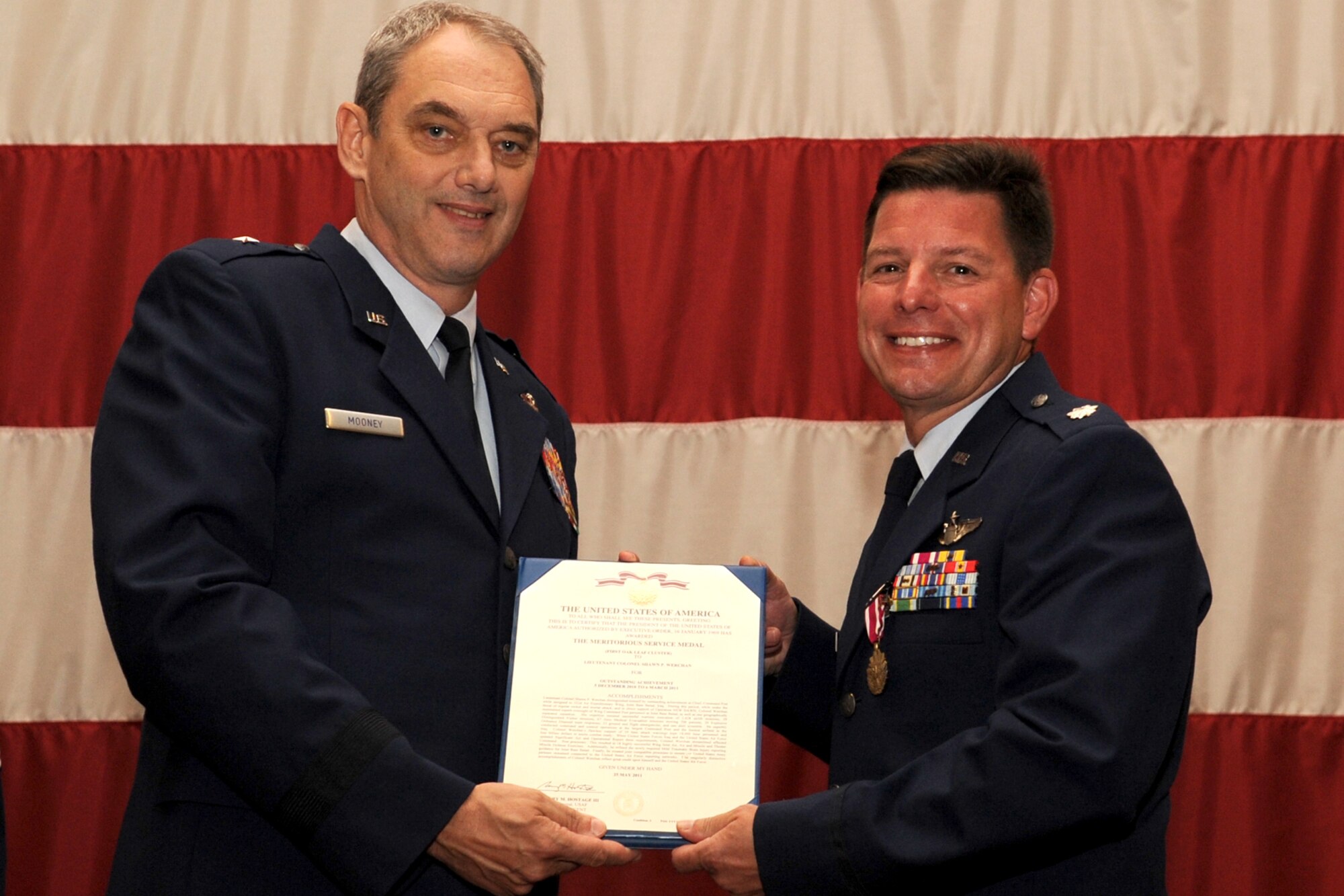U.S. Air Force Brig. Gen. John J. Mooney III, 307th Bomb Wing commander, presents the Meritorious Service Medal to Lt. Col. Shawn Werchan at Barksdale Air Force Base, La., Sept. 11, 2011. Werchan received the citation for outstanding achievement while assigned to the 332nd Air Expeditionary Wing, Joint Base Balad, Iraq, during the period of Dec. 5, 2010 to March 6, 2011. (U.S. Air Force photo by Master Sgt. Greg Steele/Released)