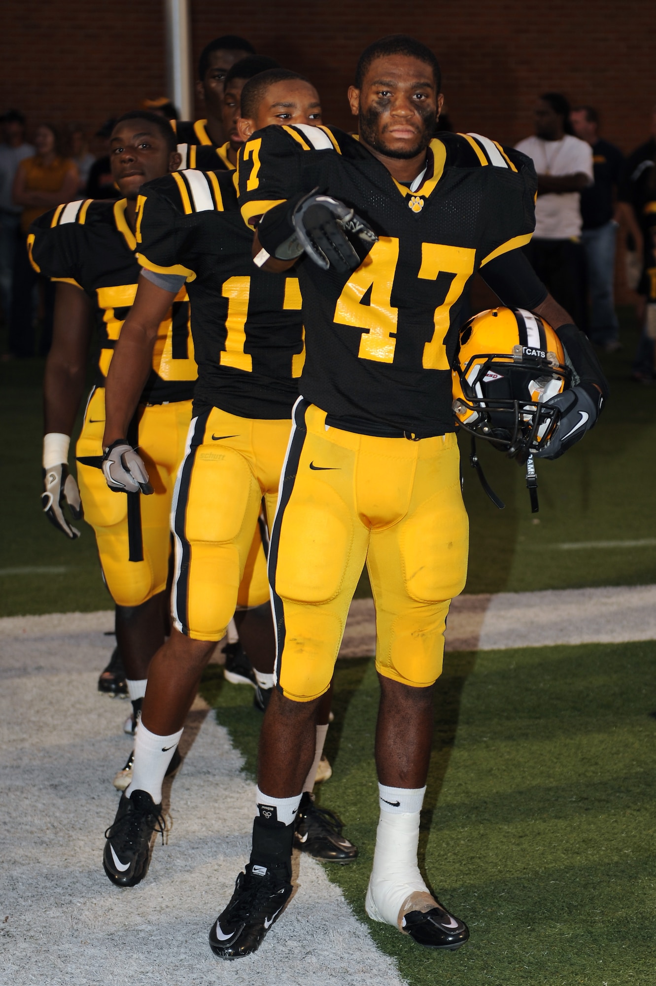Valdosta High School football team captains prepare for the coin toss at Cleveland Field, Valdosta, Ga., Sept. 9, 2011. by U.S. Air Force Col. Scott Kindsvater, 93rd Air Ground Operations Wing commander. Kindsvater performed the coin toss in support of military appreciation night.  Valdosta High School played Lincoln High School from Tallahassee, Fla. (U.S. Air Force photo by Senior Airman Ciara Wymbs/Released) 