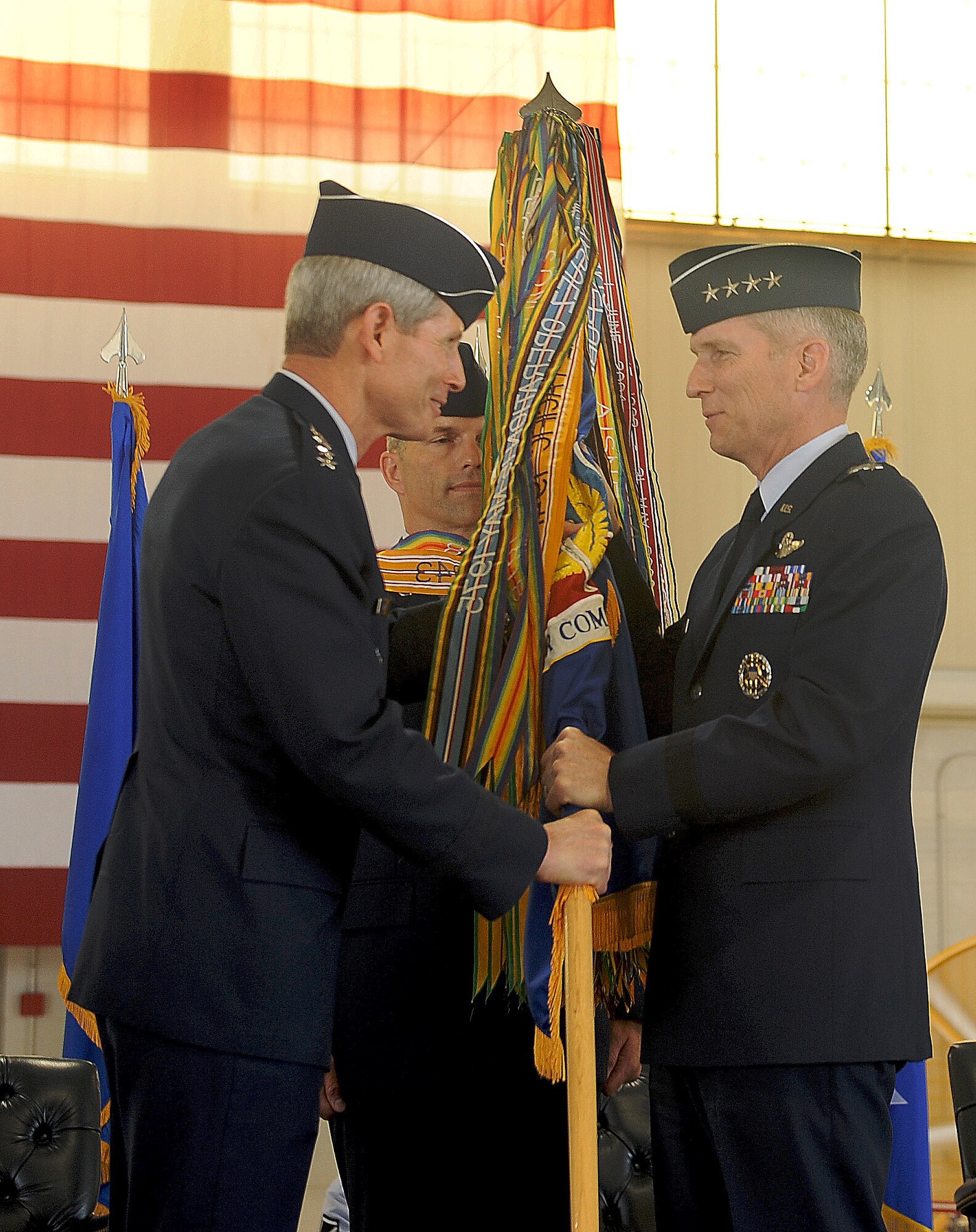 Fomer U.S. Air Force Chief of Staff Gen. Norton A. Schwartz passes the guidon to Gen. Mike Hostage during the Air Combat Command change of command ceremony at Langley Air Force Base, Va., Sept. 13, 2011. Hostage assumed command from Gen. William M. Fraser III. (U.S. Air Force photo by Staff Sgt. Antoinette Gibson/Released)