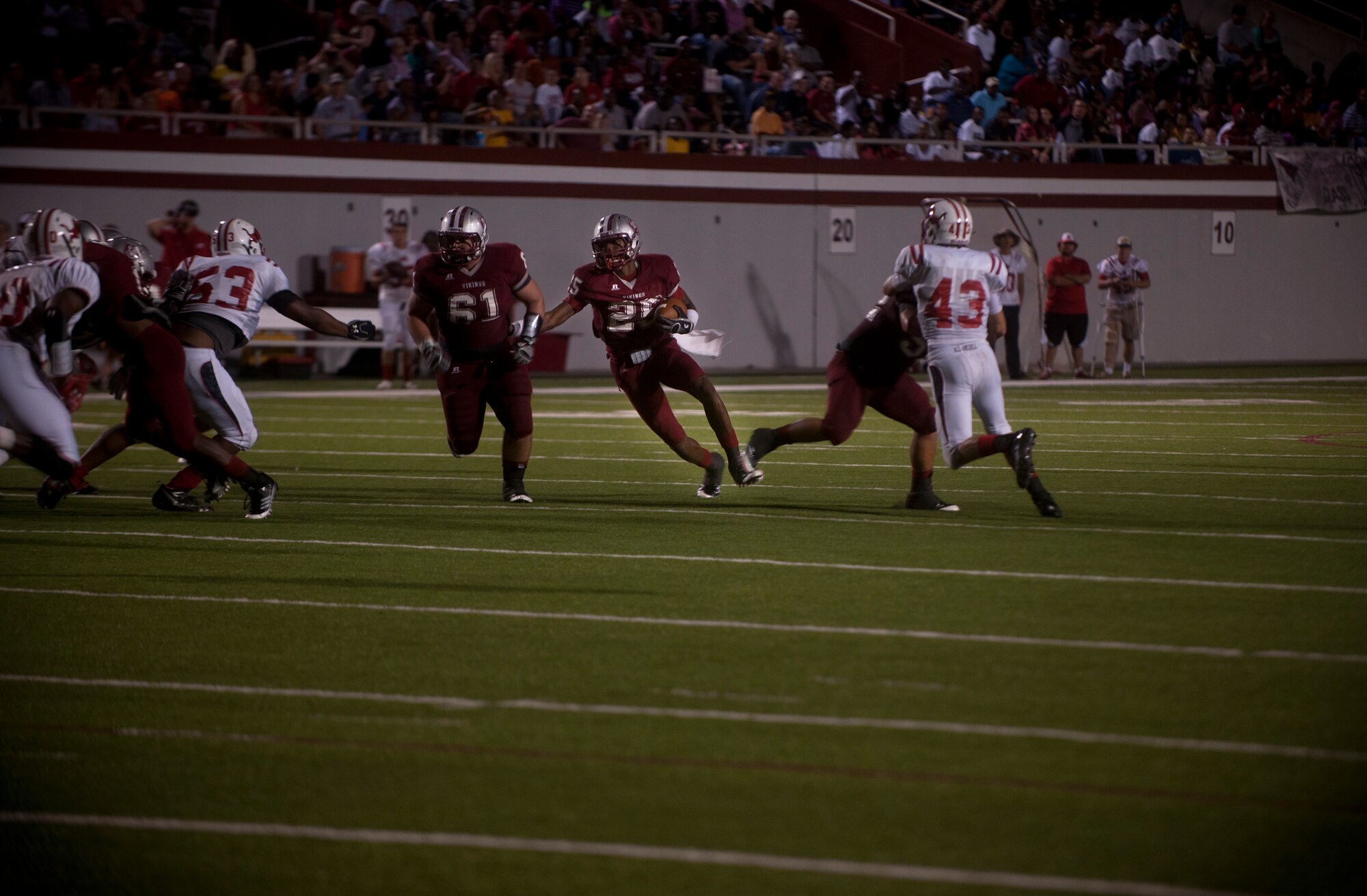 Josh Clemons, Lowndes High School quarterback, runs through a gap created by his offensive line during the game between the Lowndes High School Vikings and Tallahassee Leon Lions at Martin Stadium, Valdosta, Ga., Sept. 9, 2011. Lowndes won 39-22 and lifted their season record to 3-1. (U.S. Air Force photo by Airman 1st Class Joshua Green/Released)
