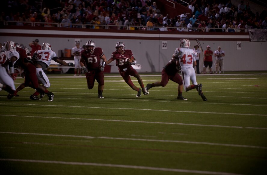 Josh Clemons, Lowndes High School quarterback, runs through a gap created by his offensive line during the game between the Lowndes High School Vikings and Tallahassee Leon Lions at Martin Stadium, Valdosta, Ga., Sept. 9, 2011. Lowndes won 39-22 and lifted their season record to 3-1. (U.S. Air Force photo by Airman 1st Class Joshua Green/Released)
