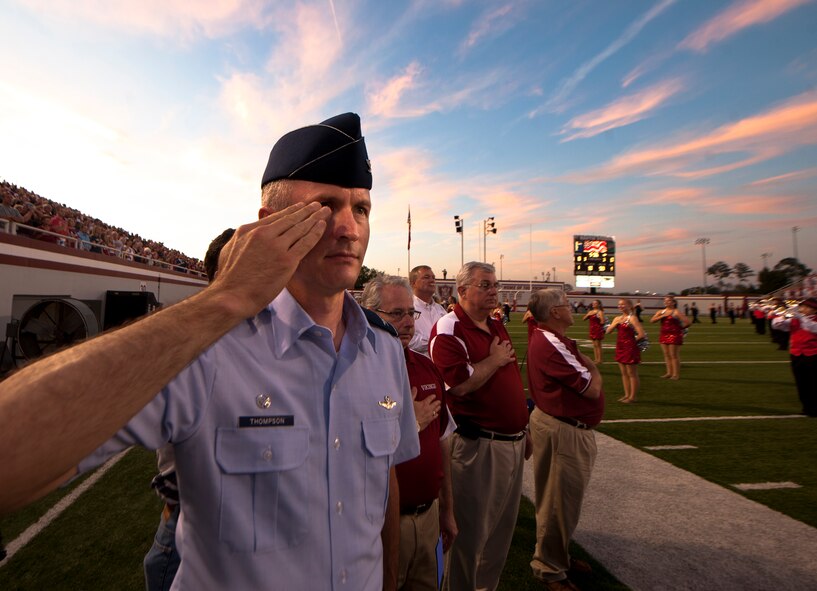 Col. Billy Thompson, 23rd Wing commander, renders a salute during the playing of the National Anthem before the Lowndes High Vikings and Tallahassee Leon Lions kickoff at Martin Stadium, Valdosta, Ga., Sept. 9, 2011. Thompson delivered the coin toss in honor of Military appreciation day. (U.S. Air Force photo by Airman 1st Class Joshua Green/Released)
