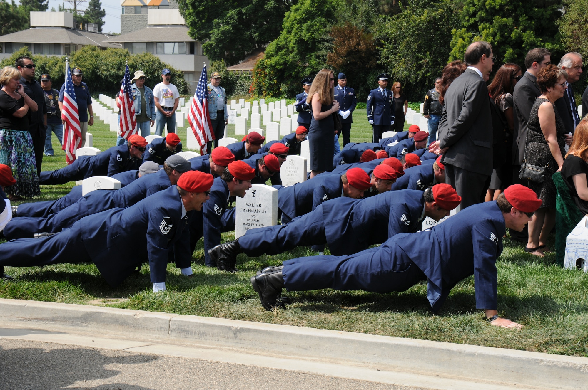 Teammates of Staff Sgt. Andrew Harvell perform memorial push-ups in his honor during his funeral at Los Angeles National Cemetery Sept. 10. It's customary to end them with a chant, "One for teamwork, one for fallen comrades and one for big Andy. Hooyah." Harvell was a combat controller who died Aug. 6 when the CH-47 helicopter he was traveling in crashed in the Wardak province of Afghanistan.  Harvell was one of 30 Americans who died.  (U.S. Air Force photo by Joe Juarez)