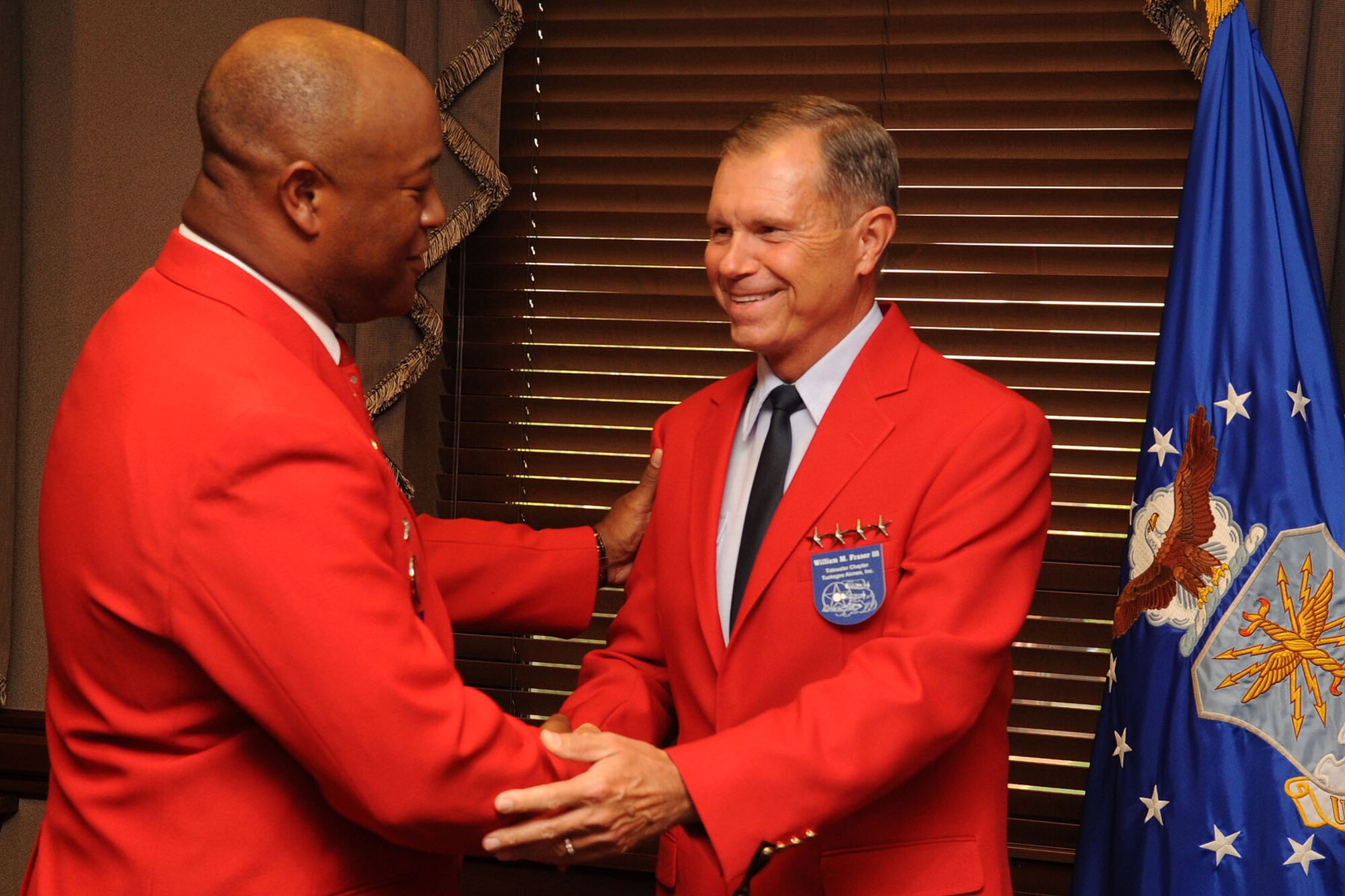 T.J. Spann, Tidewater Chapter- Tuskegee Airmen Incorporated president, welcomes U.S. Air Force Gen. William M. Fraser III, commander of Air Combat Command, as an honorary Tuskegee Airmen at Langley Air Force Base, Va., Sept. 8, 2011. Fraser became the fifth honorary member in the Tidewater Tuskegee Airmen’s chapter in their 30-year history. (U.S. Air Force photo by Airman 1st Class Racheal Watson/Released)