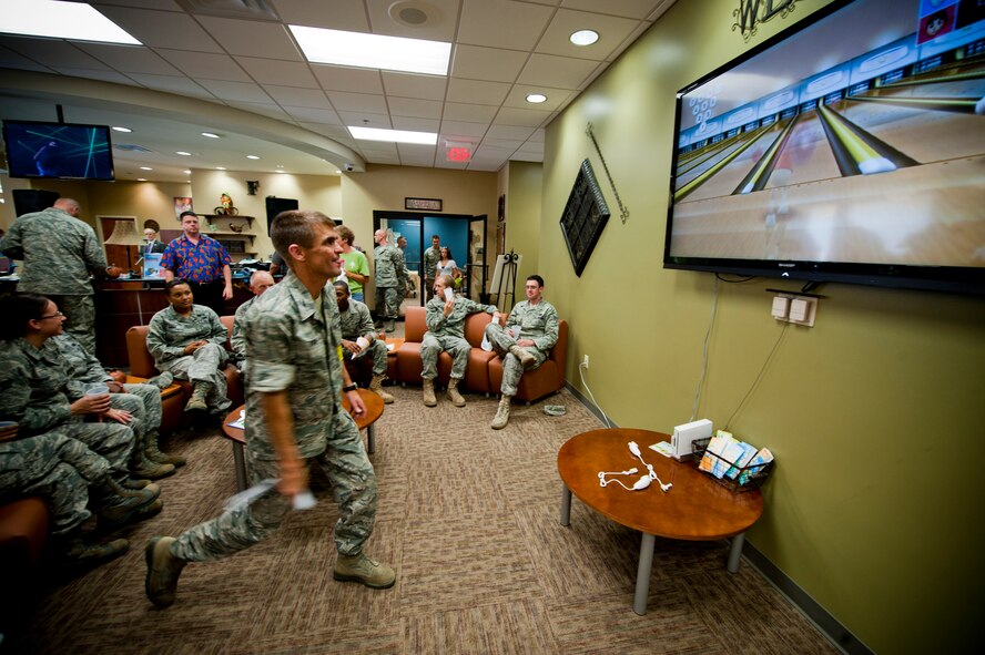 U.S. Air Force Col. Mark Ruse, commander, 23rd Mission Support Group, plays an interactive video game during the grand opening of "The Spot" on Moody Air Force Base, Ga., Sept. 9, 2011. The Spot which is open to all ID card holders offers a modern environment for Airmen to spend their down time. (U.S. Air Force photo by Staff Sgt. Joshua J. Garcia/Released)