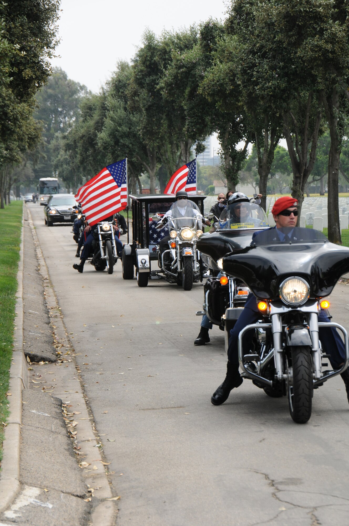 The casket of Staff Sgt. Andrew Harvell is carried to his final resting place at Los Angeles National Cemetery by a glass caisson, pulled by a motorcycle hearse company.  Harvell was a combat controller who died Aug. 6 when the CH-47 helicopter he was traveling in crashed in the Wardak province of Afghanistan.  Harvell was one of 30 Americans who died.  (U.S. Air Force photo by Joe Juarez)