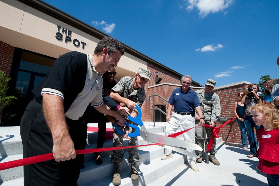Eric Boucher, the bowling center manager for the 23rd Force Support Squadron and U.S. Air Force Col. Mark Ruse, commander, 23rd Mission Support Group, cut the ribbon during the grand opening of "The Spot" on Moody Air Force Base, Ga., Sept. 9, 2011. The Spot, a facility that cost approximately 3 million dollars to build, offers an array of entertainment for members of Team Moody. (U.S. Air Force photo by Staff Sgt. Joshua J. Garcia/Released)