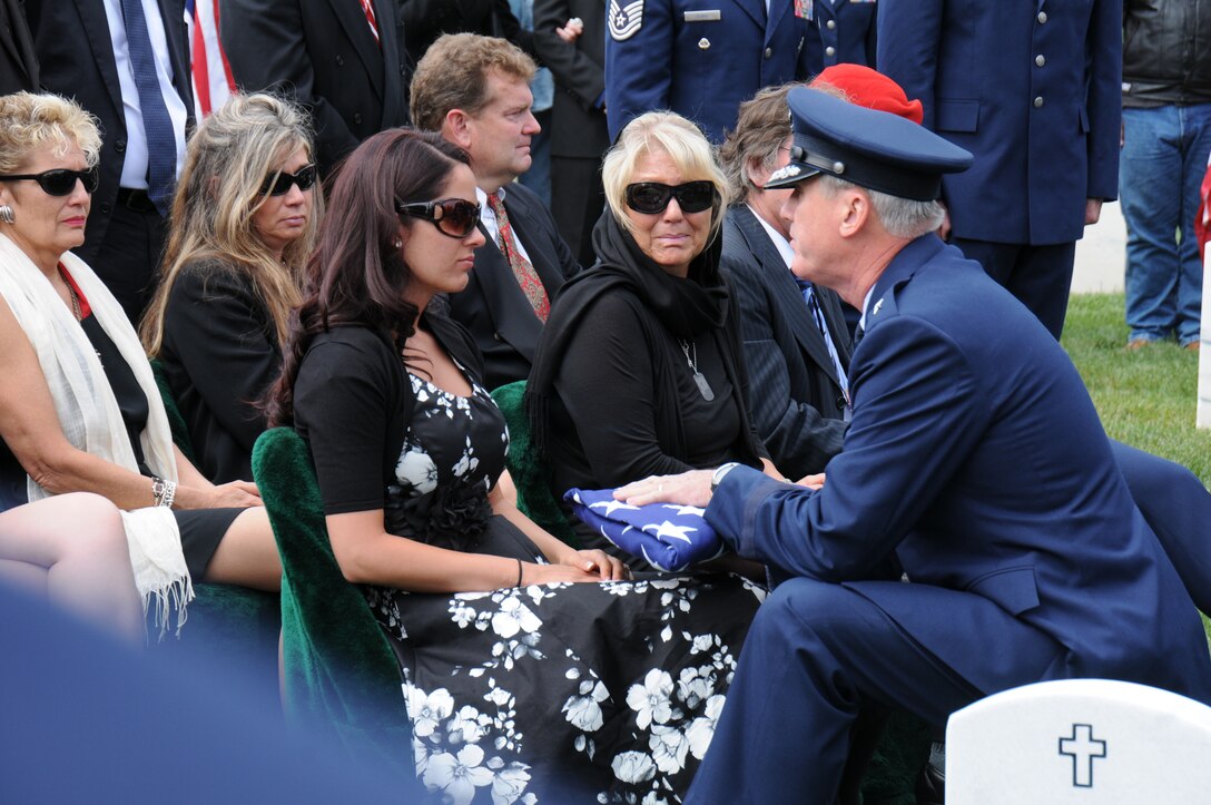 Maj. Gen. O.G. Mannon, vice commander of Air Force Special Operations Command, presents a flag to Krista Harvell during her husband's funeral at Los Angeles National Cemetery Sept. 10.  Krista is the wife of Staff Sgt. Andrew Harvell, a combat controller who died Aug. 6 when the CH-47 helicopter he was traveling in crashed in the Wardak province of Afghanistan.  Harvell was one of 30 Americans who died.  (U.S. Air Force photo by Joe Juarez)