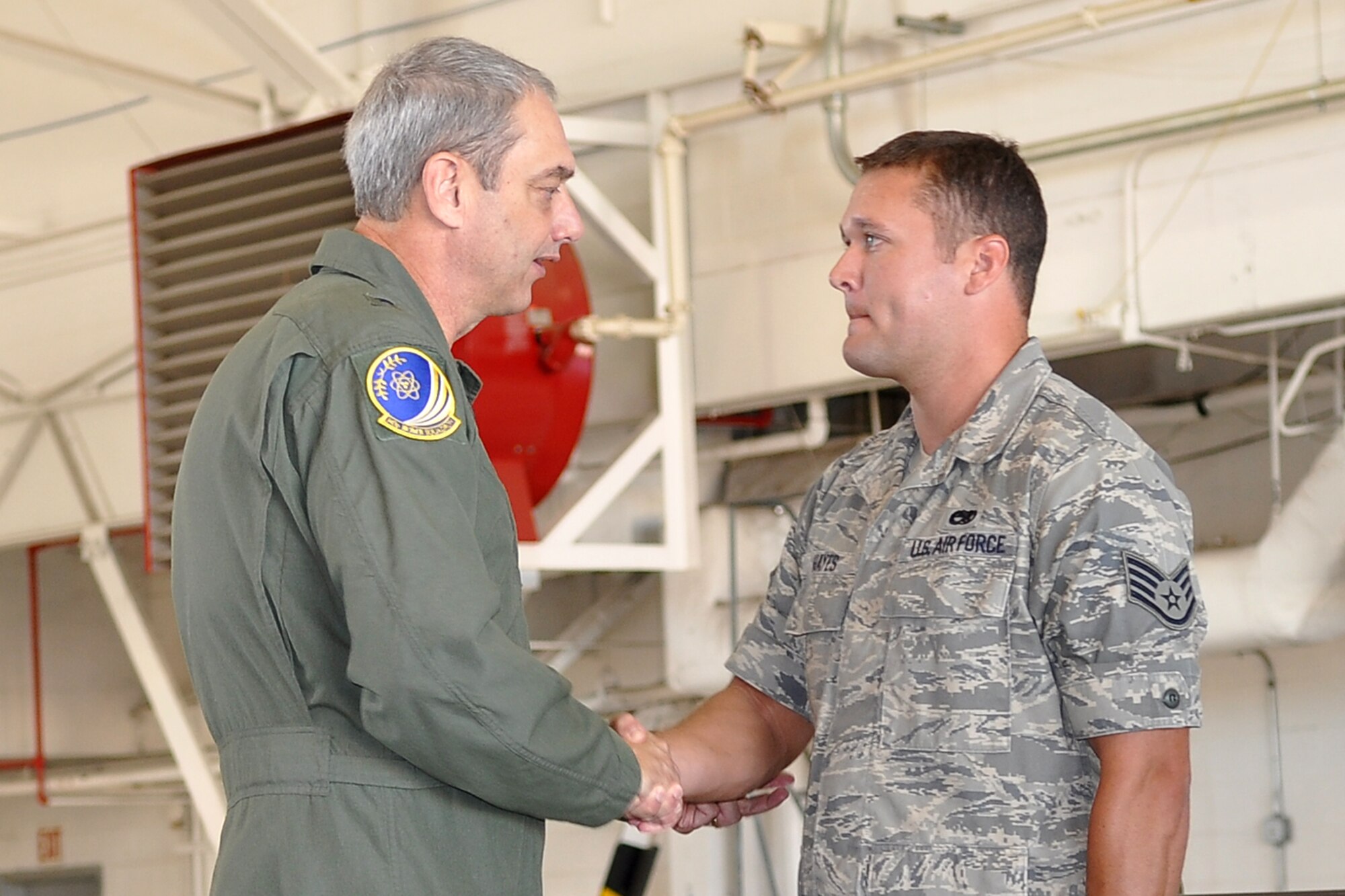 Brig. Gen. John J. Mooney III, the 307th Bomb Wing commander, congratulates Staff Sgt. Daniel C. Hayes of the 307th Maintenance Squadron during a non-commissioned officer’s induction ceremony at Barksdale Air Force Base, La., Sept. 10, 2011. Hayes was one of several new NCOs honored at the ceremony. (U.S. Air Force Photo by Staff Sgt. Ted Daigle/Released)