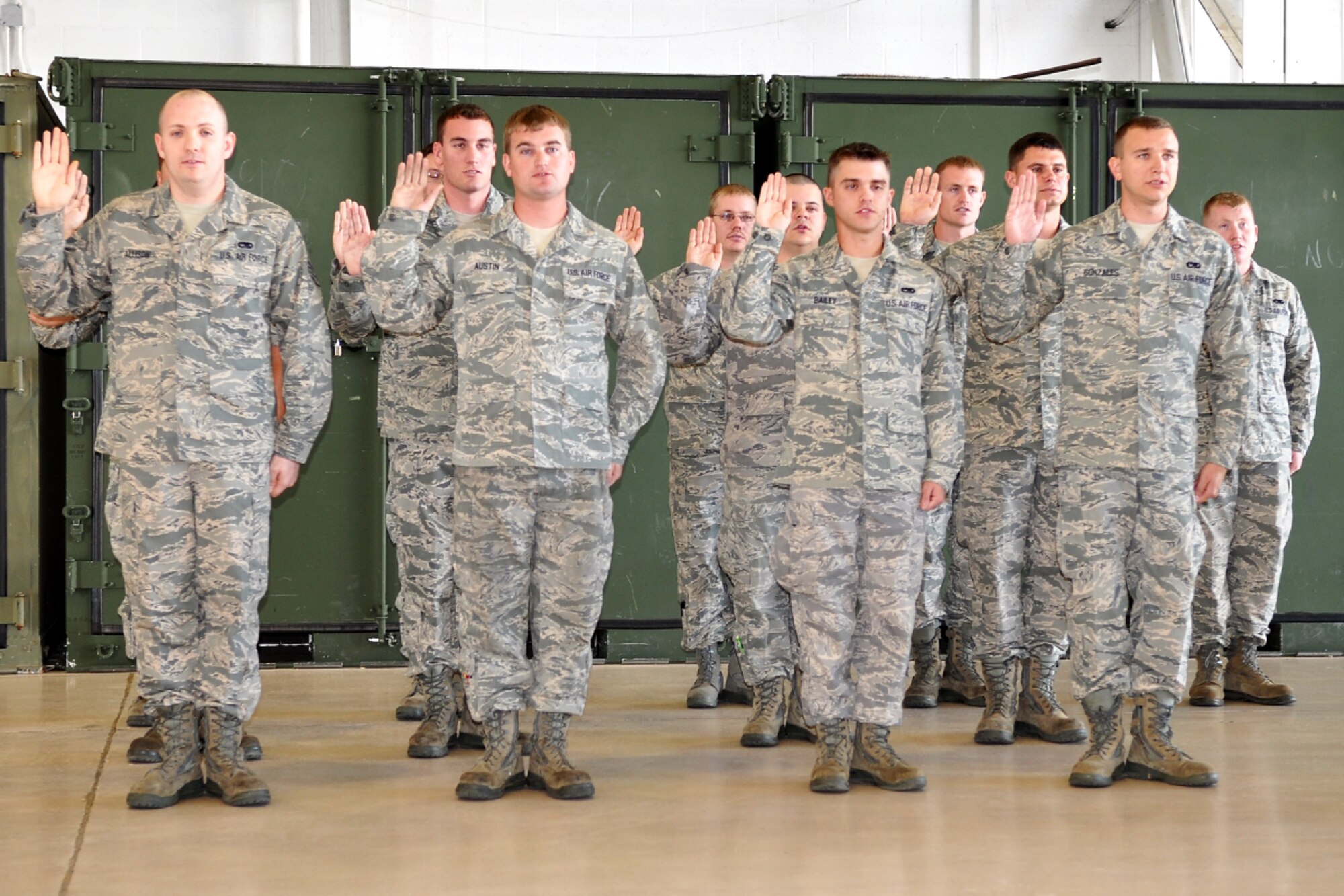 Airmen of the 307th Maintenance Group raise their right hands to be sworn in as Air Force non-commissioned officers at Barksdale, Air Force Base, La., Sept. 10, 2011. Family, friends and fellow squadron members gathered to honor the new NCOs during an induction ceremony on the base. (U.S. Air Force photo by Staff Sgt. Ted Daigle/Released) 