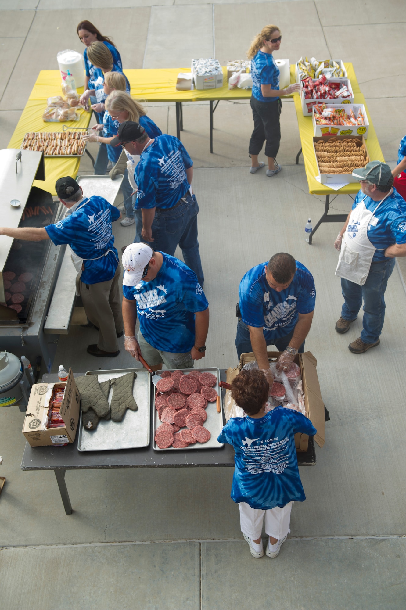 HOLLOMAN AIR FORCE BASE, N.M. -- Volunteers from the local community cook hot dogs and hamburgers in the dormitory courtyard Sept. 9, 2011, during this year’s “Thanks Team Holloman.” This annual event  is supported by the Alamogordo community to show their appreciation for Team Holloman. (U.S. Air Force photo by Airman 1st Class Joshua Turner/Released)