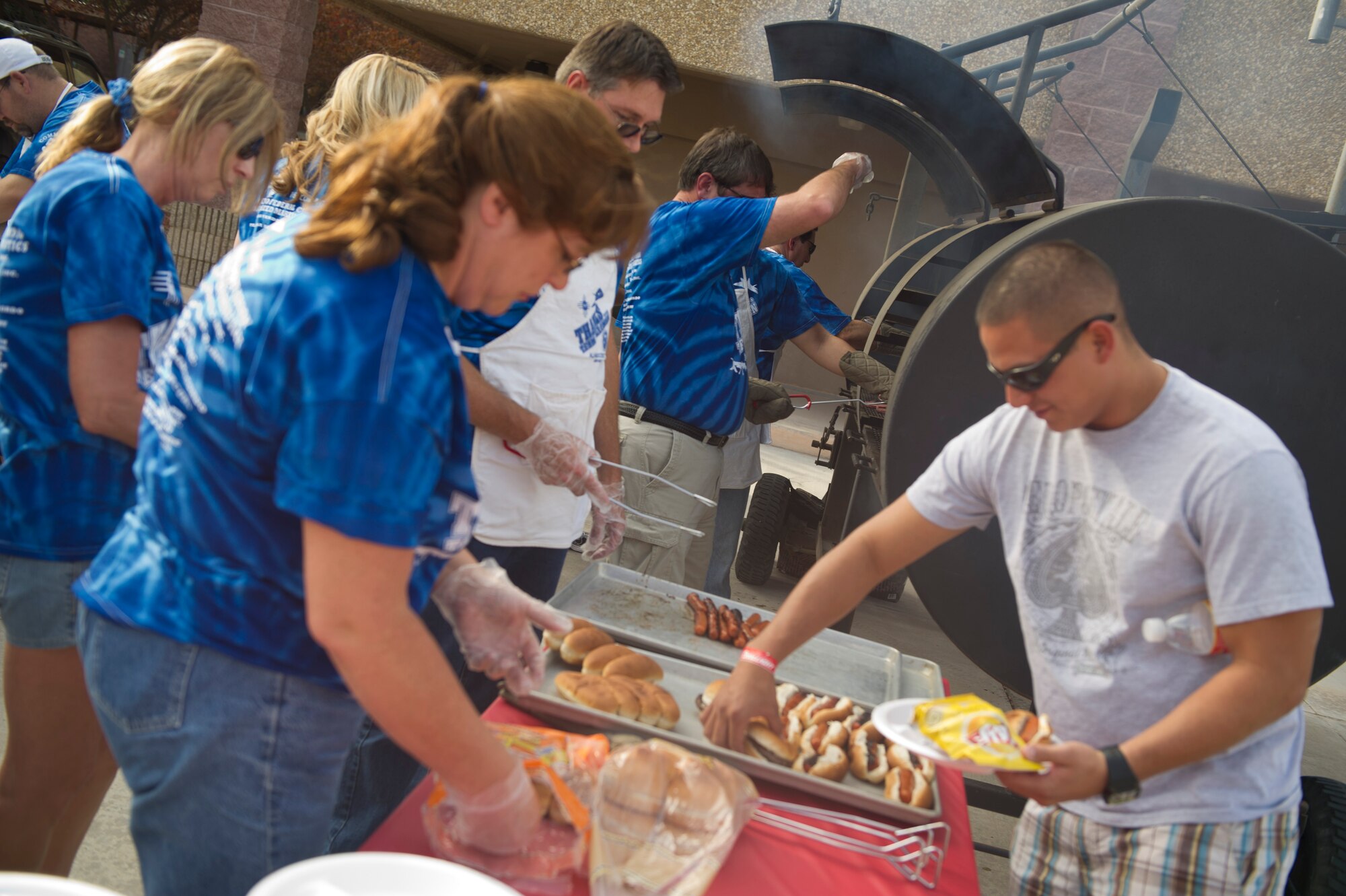 HOLLOMAN AIR FORCE BASE, N.M. -- Volunteers from the local community serve food to members of Holloman in the dormitory courtyard Sept. 9, 2011, during this year’s “Thanks Team Holloman.” This annual event is hosted by the Committee of 50 and local businesses from Alamogordo to show their appreciation for Team Holloman. (U.S. Air Force photo by Airman 1st Class Joshua Turner/Released) 
