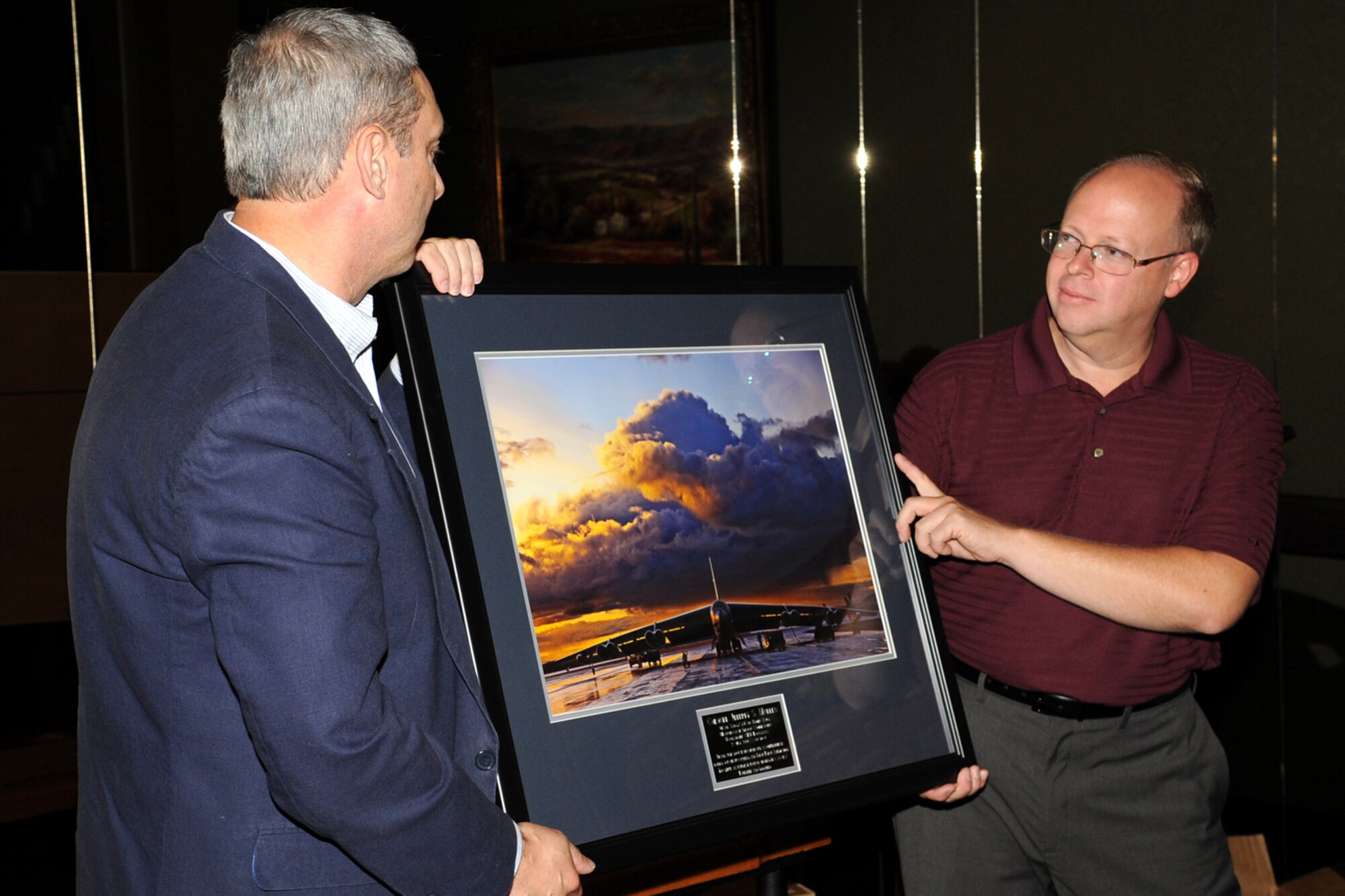 U.S. Air Force Brig. Gen. John J. Mooney III, 307th Bomb Wing commander, presents U.S. Air Force Col. Jeffrey Mullen, 307th Maintenance Group commander, with picture of a B-52 bomber during a going away dinner in Shreveport, La., Sept. 9, 2011. Mullen, who served 4 years as commander, is leaving the wing for a new assignment at 10th Air Force, Naval Air Station Joint Reserve Base Fort Worth, Texas. (U.S. Air Force photo by Master Sgt. Greg Steele/Released)