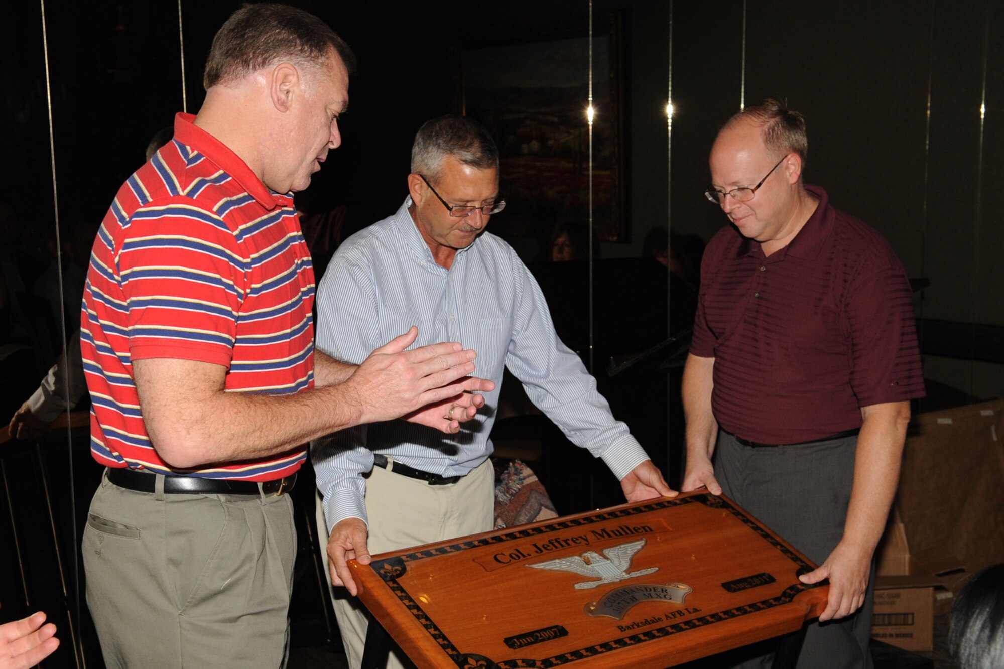U.S. Air Force Maj. Leo Kamphaus, 307th Maintenance Squadron commander, and U.S. Air Force Chief Master Sgt. Robert Murray, 307th Maintenance Squadron superintendent, present U.S. Air Force Col. Jeffrey Mullen, 307th Maintenance Group commander, with a custom made table during a going away dinner in Shreveport, La., Sept. 9, 2011. Mullen, who served 4 years as commander, is leaving the wing for a new assignment at 10th Air Force, Naval Air Station Joint Reserve Base Fort Worth, Texas. (U.S. Air Force photo by Master Sgt. Greg Steele/Released)