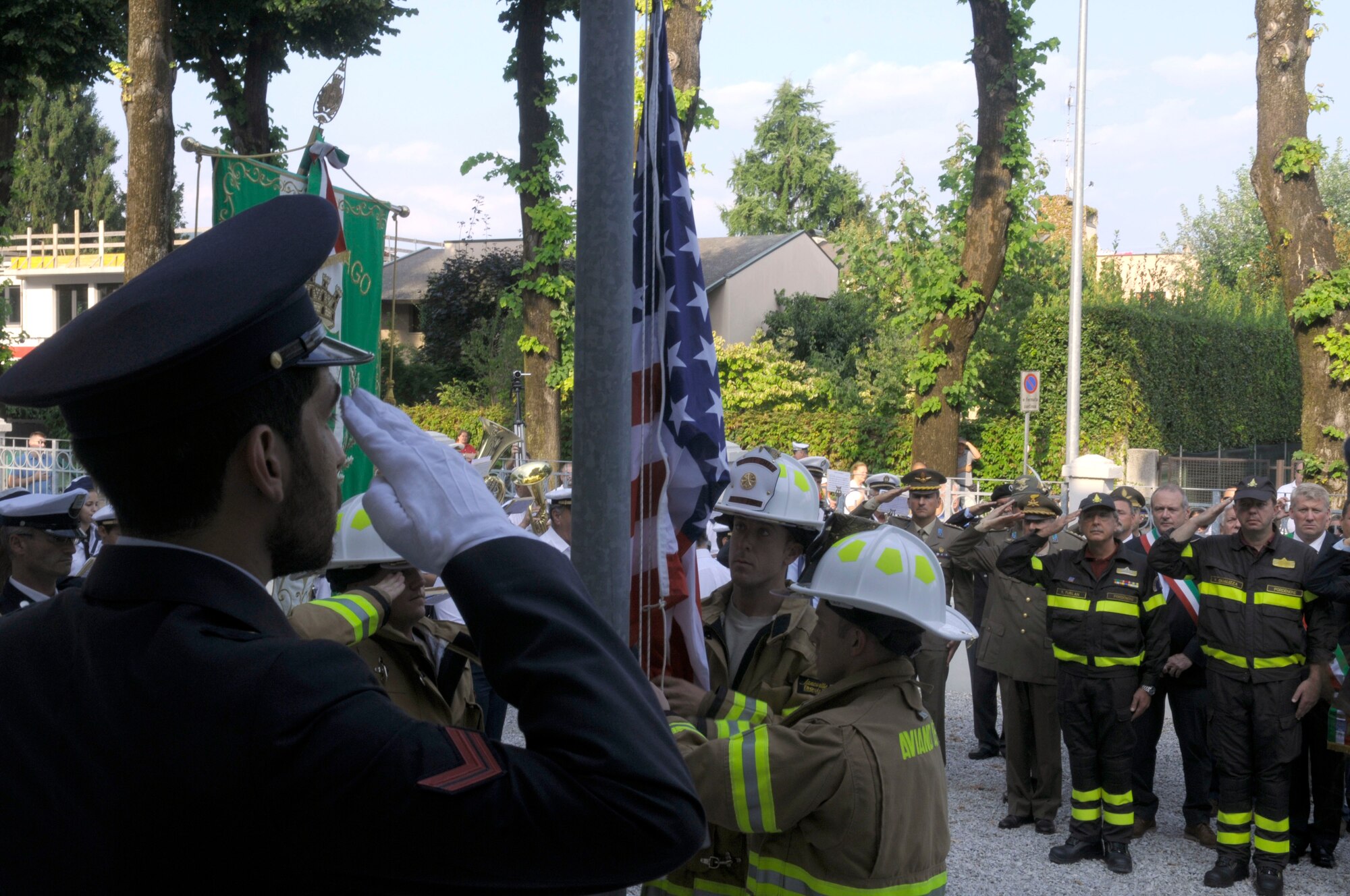 Aviano Air Base firefighters raise the American flag during a 9/11 commemoration Sept. 10 at the Italian-American Friendship Festival in Maniago, Italy. (U.S. Air Force photo/2nd Lt. Joseph Alonso)
