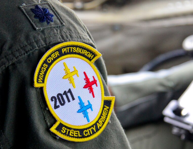 PITTSBURGH, PA -- A pilot from the 758th Airlift Squadron wears the Wings Over Pittsburgh 2011 Air Show patch while flying a C-130 Hercules over the air show, Sept. 11. The C-130 carried U.S. Army C-219 Special Forces Group (Airborne) members, who parachuted to the ground as an aerial demonstration. (U.S Air Force/Senior Airman Jonathan Hehnly)
