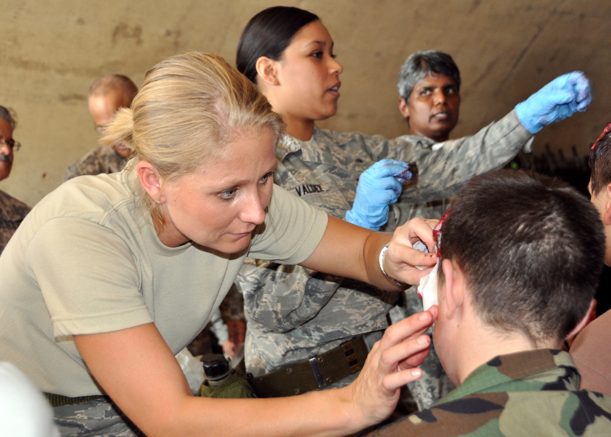 Captain Nicole Benavides 301st MDS, left, applies moulage make up to a Civil Air Patrol cadet in preparation for the in preparation for the joint Mass Casualty Exercise held at the Army Reserve Center, Fort Worth, September 10 and 11. CAP cadets acted as injured personnel during the two-day exercise which pulled together military and civilian units and emergency responders from around the area.  (U.S. Air Force photo/Staff Sgt Chris Bolen)