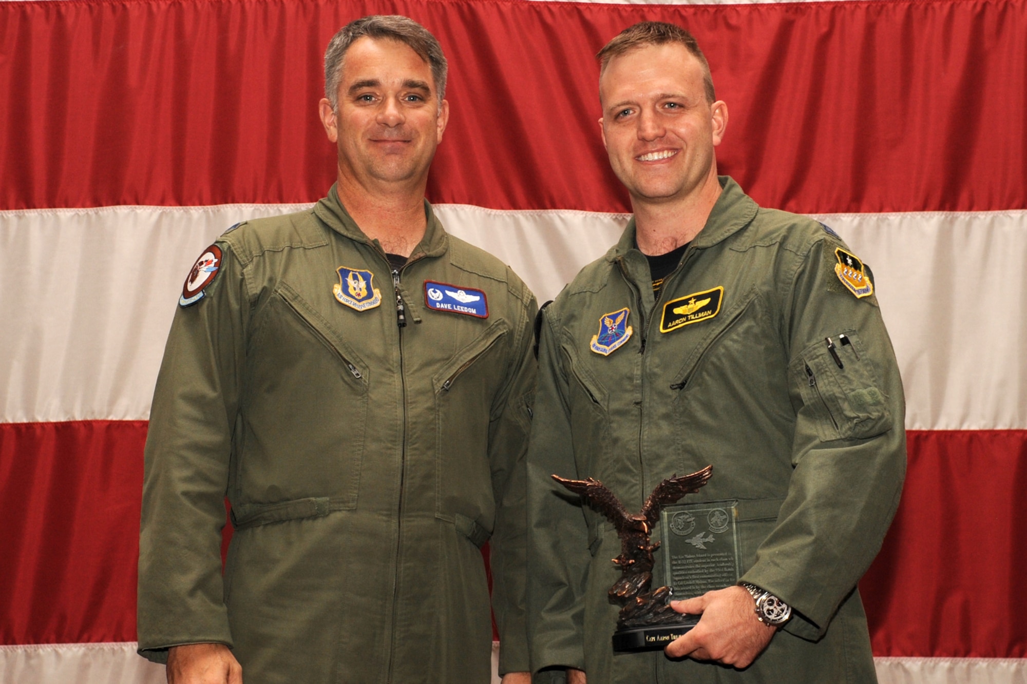 U.S. Air Force Lt. Col. Dave Leedom, 93rd Bomb Squadron commander, presents Capt. Aaron Tillman, a B-52 student pilot and member of class 11-01, with the Lindell Mabus Leadership Award during a graduation ceremony, 307th Bomb Wing, Barksdale Air Force Base, La., Sept. 9, 2011. The award is presented to the outstanding leader of the class and the recipient is chosen by fellow classmates. (U.S. Air Force photo by MSgt. Greg Steele/Released)