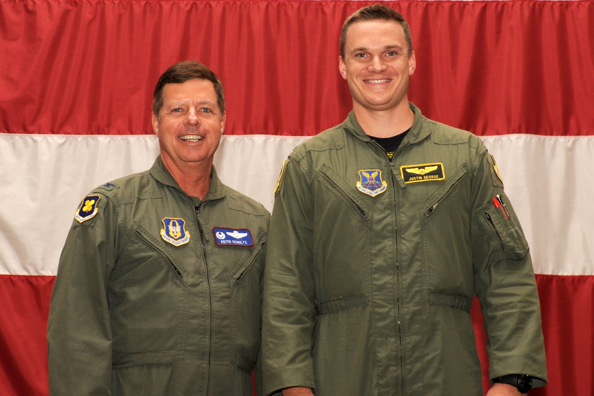 U.S. Air Force Col. Keith Schultz, 307th Operations Group commander, presents the Copilot Distinguished Graduate certificate to 1st Lt. Justin George, student copilot and member of class 11-01, during a graduation ceremony, 307th Bomb Wing, Barksdale Air Force Base, La., Sept. 9, 2011. George graduated with an overall grade point average of 93.04 percent. (U.S. Air Force photo by Master Sgt. Greg Steele/Released)