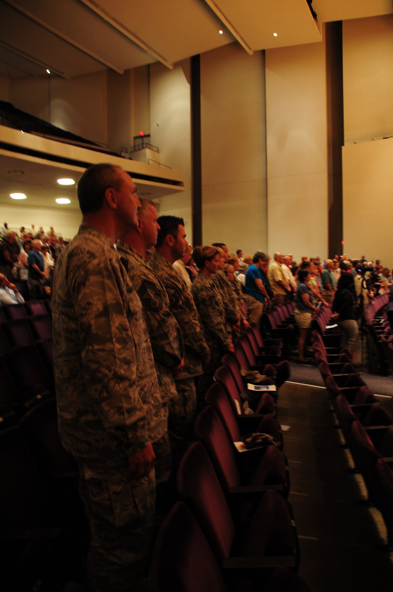 Members of the 148th Fighter Wing stand during a prayer sung by a rabbi during the 9/11 tribute held at the DECC in Duluth, Minn., Sept. 11, 2011.  (U.S. Air Force photo by Tech. Sgt. Scott G. Herrington)