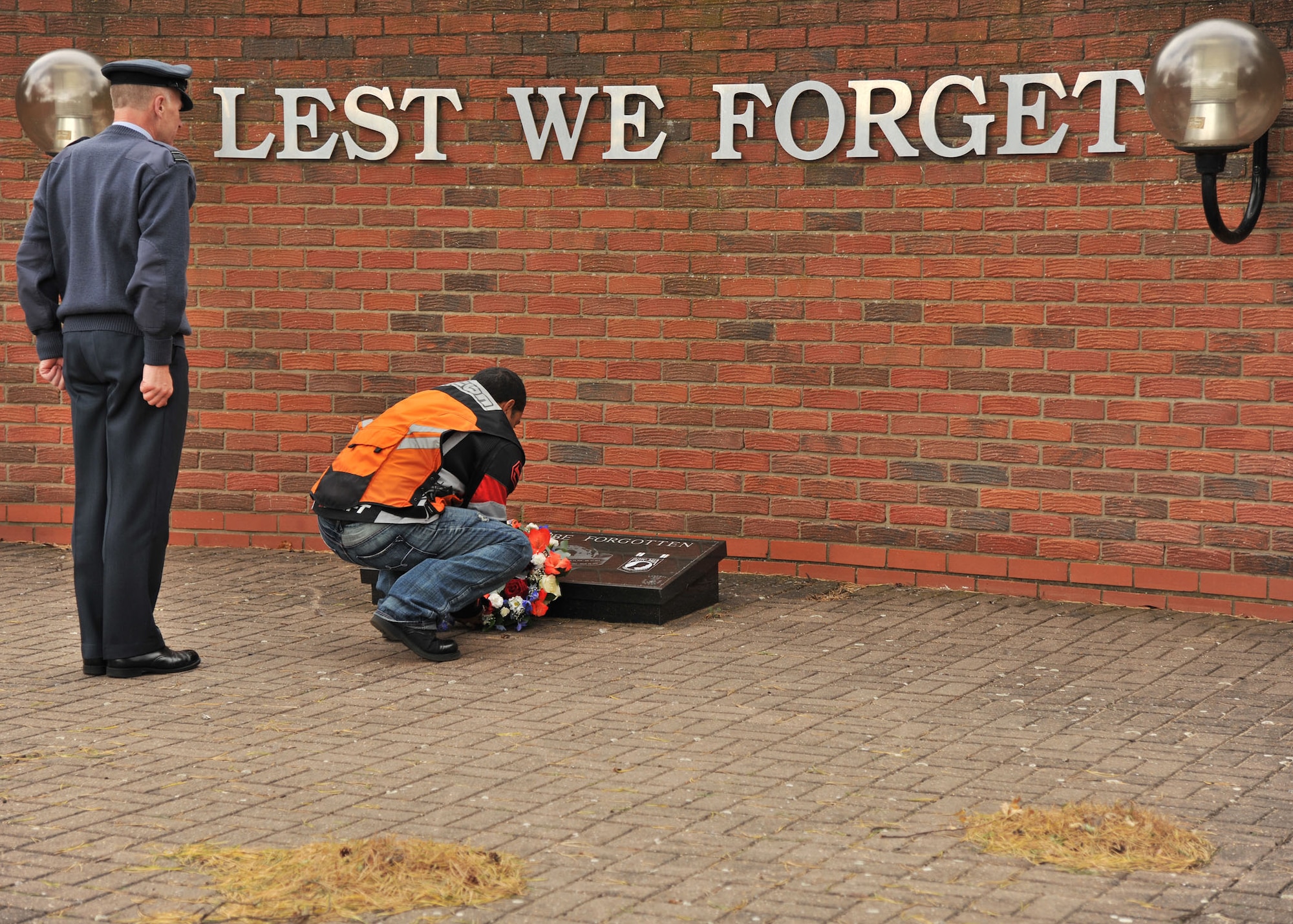RAF MILDENHALL, England – Staff Sgt. Jose Contreras, 48th Equipment Maintenance Squadron, RAF Lakenheath, places a wreath on the Prisoner of War/Missing in Action memorial plaque at Memorial Park on RAF Lakenheath Sept. 13, 2011. More than 50 Airmen participated in the POW/MIA Rolling Thunder Remembrance Motorcycle Ride as part of the POW/MIA Remembrance week. (U.S. Air Force photo by Senior Airman Jerilyn Quintanilla)