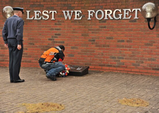 RAF MILDENHALL, England – Staff Sgt. Jose Contreras, 48th Equipment Maintenance Squadron, RAF Lakenheath, places a wreath on the Prisoner of War/Missing in Action memorial plaque at Memorial Park on RAF Lakenheath Sept. 13, 2011. More than 50 Airmen participated in the POW/MIA Rolling Thunder Remembrance Motorcycle Ride as part of the POW/MIA Remembrance week. (U.S. Air Force photo by Senior Airman Jerilyn Quintanilla)