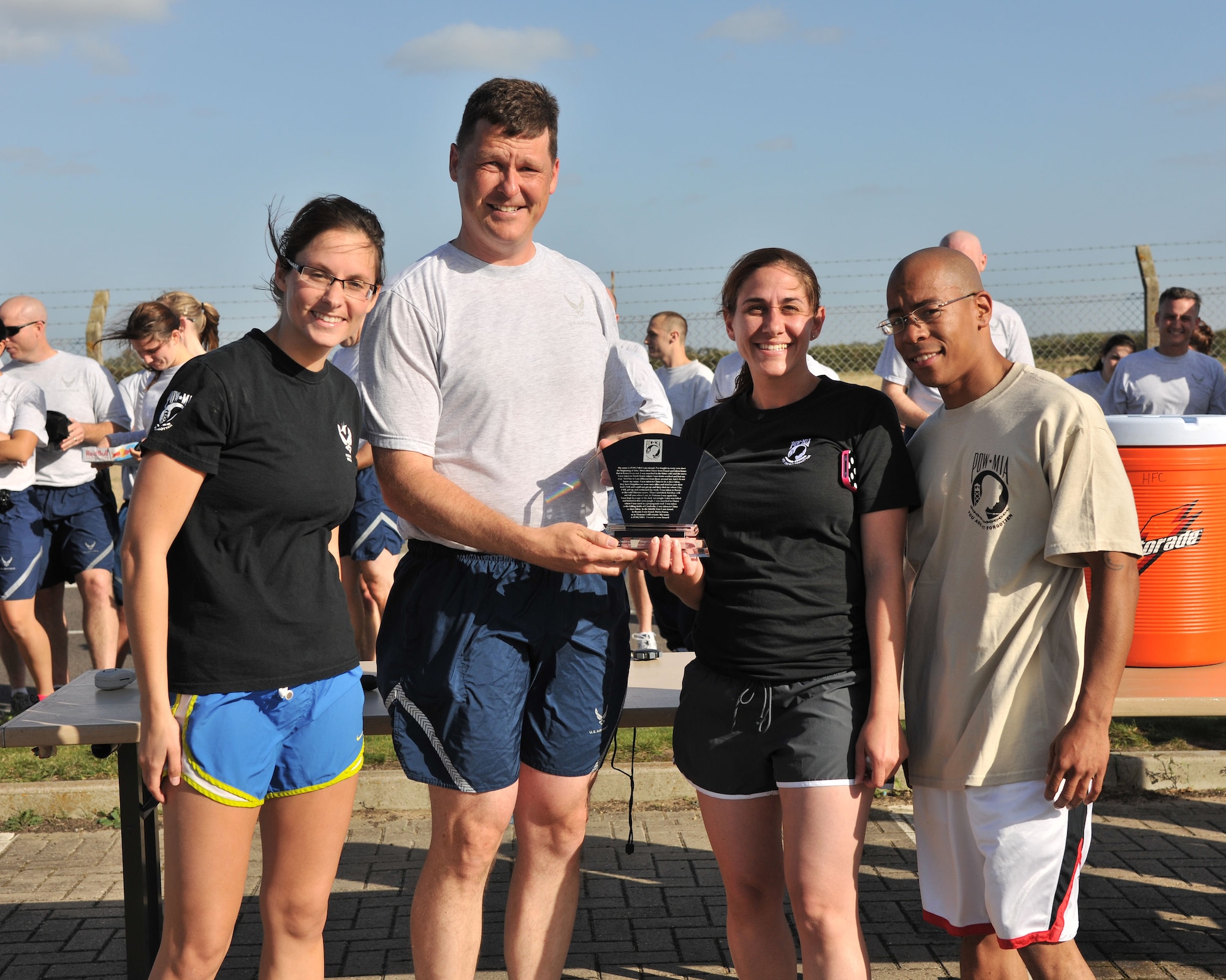 RAF MILDENHALL, England – Col. David Doe, 100th Mission Support Group commander, presents the Team Spirit Award to Airmen representing the 95th Reconnaissance Squadron following the Prisoner of War/ Missing in Action 5K team run here Sept. 12, 2011. The run was hosted by the 100th Air Refueling Wing.  Several other events will be held throughout POW/MIA Remembrance week to include a luncheon and base retreat ceremony. (U.S. Air Force photo by Senior Airman Jerilyn Quintanilla)