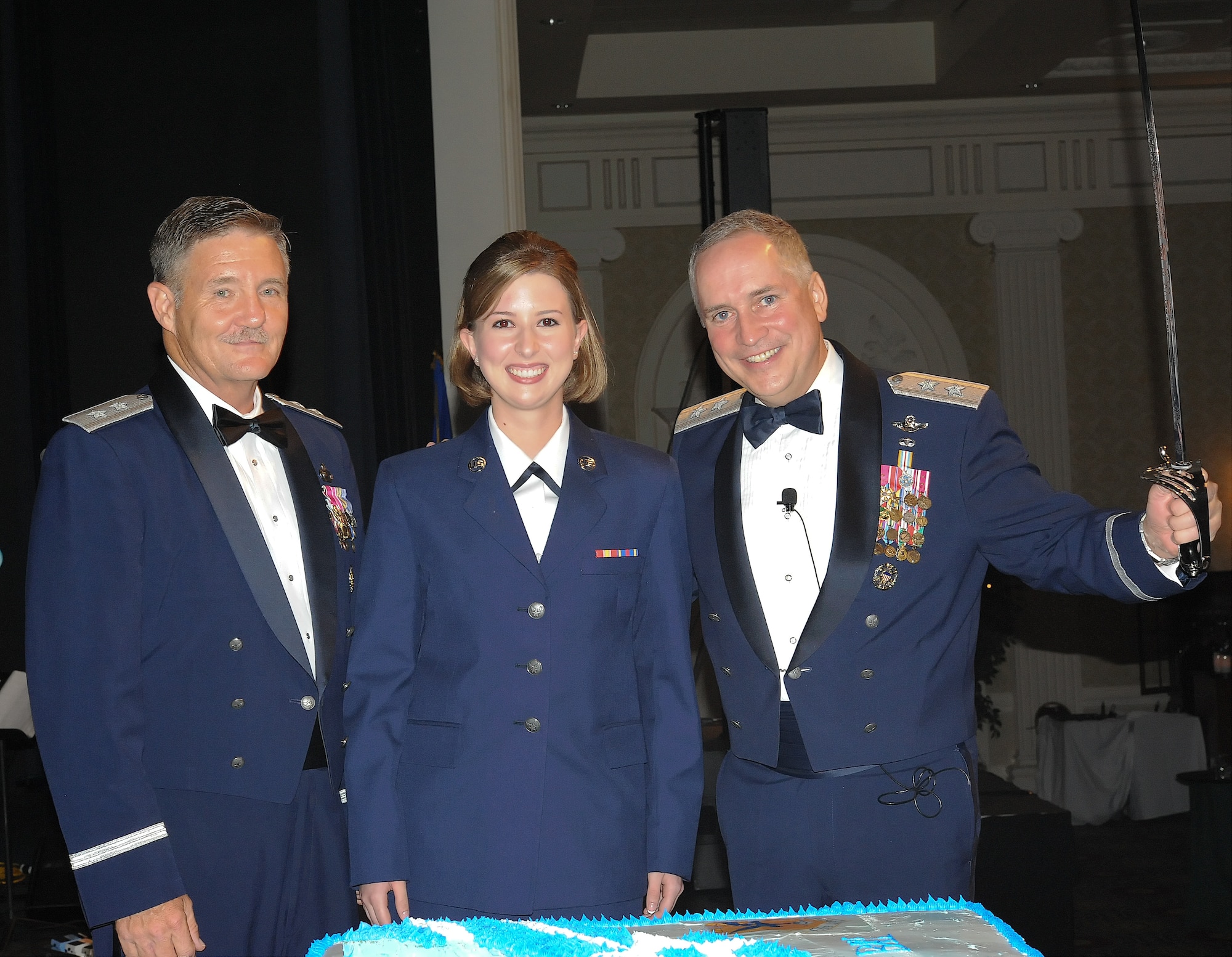 Maj. Gen. Hugh Broomall (left), the special assistant to the director of the Air National Guard; Airman Amanda Warga, a port mortuary operations team member with Air Force Mortuary Affairs Operations Center; and Maj. Gen. Frederick Martin, the director of operations with Air Mobility Command, prepare to cut the Air Force’s birthday cake during the Air Force Ball Sept. 9, 2011, at Dover Downs, Del. More than 500 Team Dover members attended the Ball in commemoration of the Air Force’s 64th birthday. (U.S. Air Force photo by Airman 1st Class Samuel Taylor)