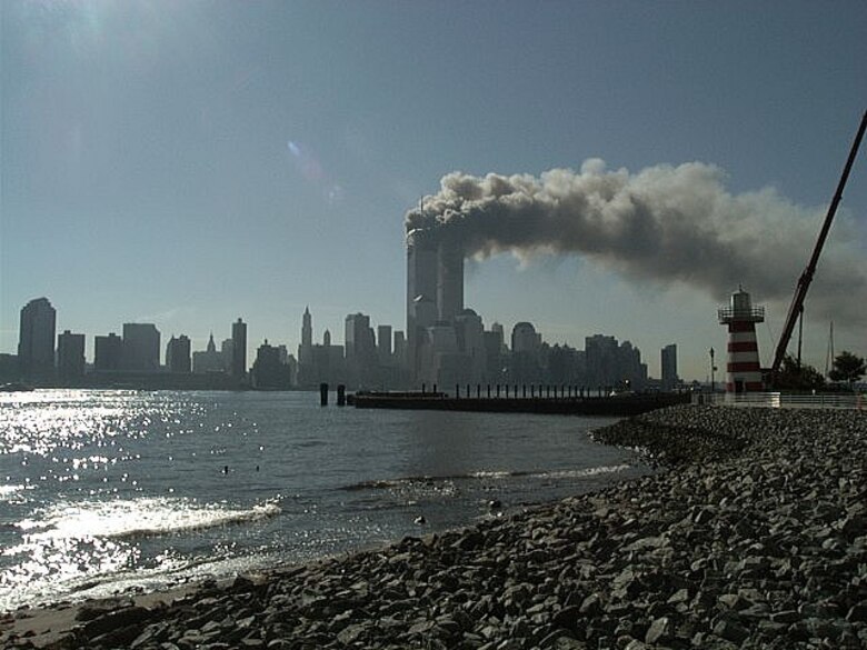The two towers of the World Trade Center in New York City, burn after being attacked by terrorists Sept. 11, 2001. (Courtesy photo by Mari Schwanke/Released)